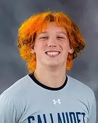 Jaden Dingel - 2026 Gallaudet men’s volleyball headshot. The Bison team manager wears a gray t-shirt and looks towards the camera. A gray backdrop is in the background.