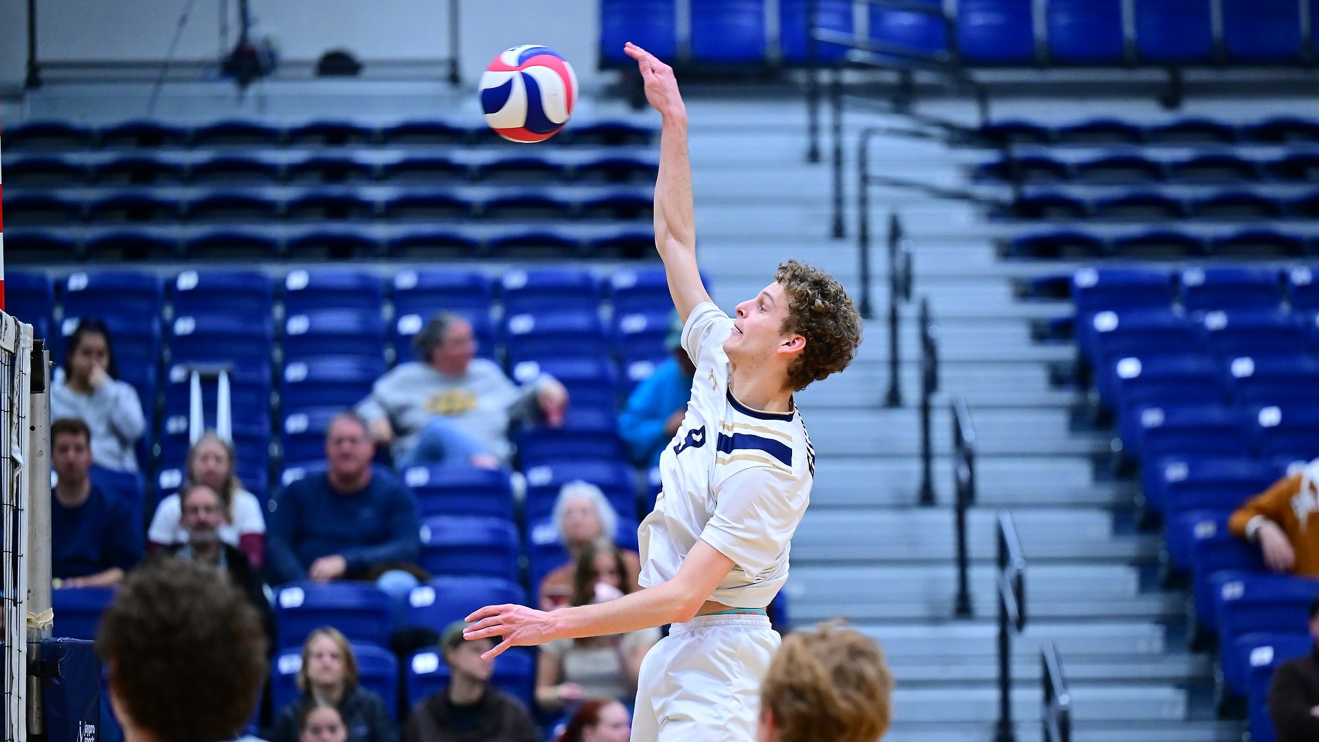 Gallaudet men's volleyball player Zachary Bippus makes a spike in a home match in the Field House.