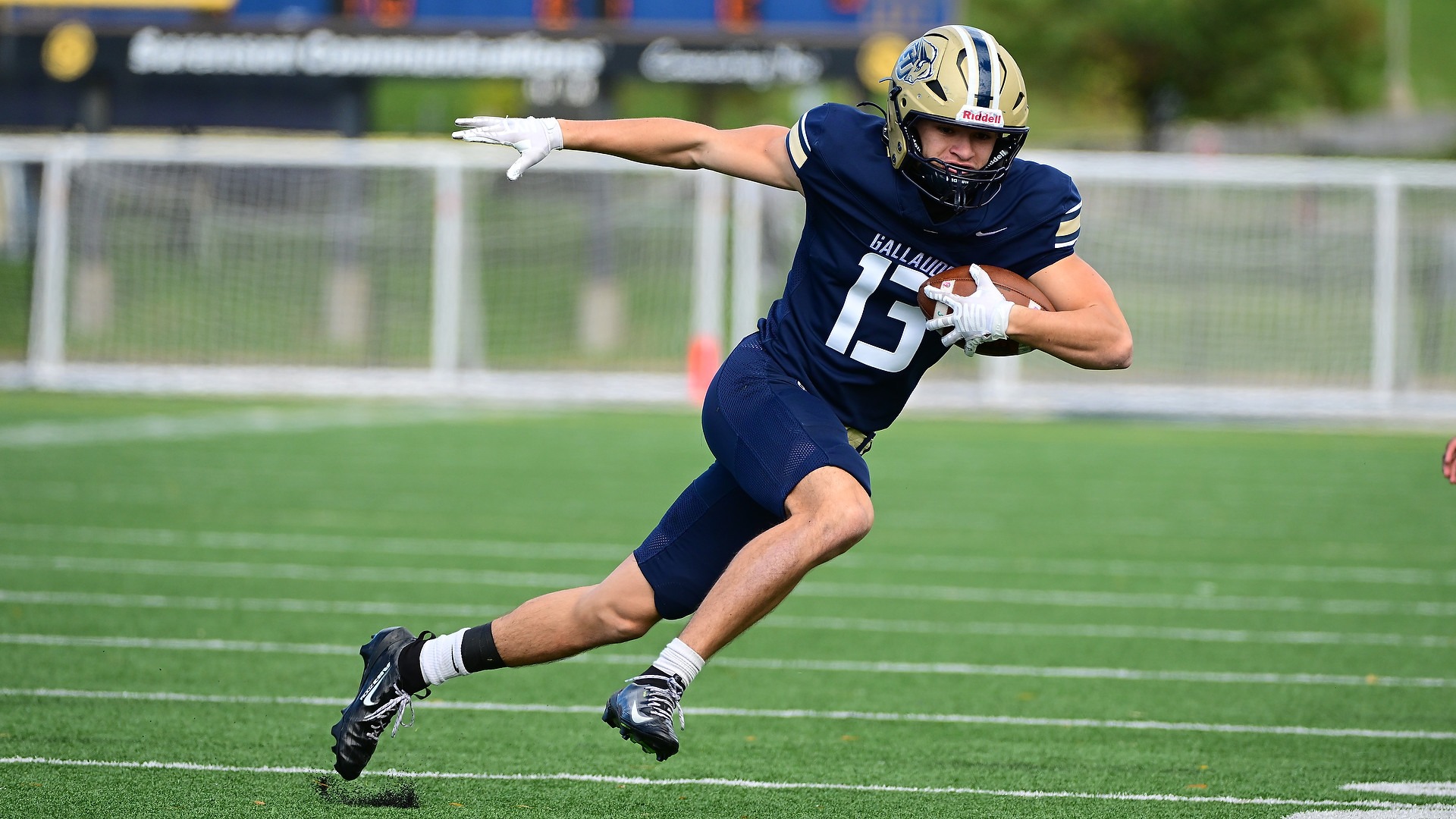 Gallaudet University football wide receiver Isaiah Baxter makes a catch during a game and runs upfield during a day game at Hotchkiss Field. 
