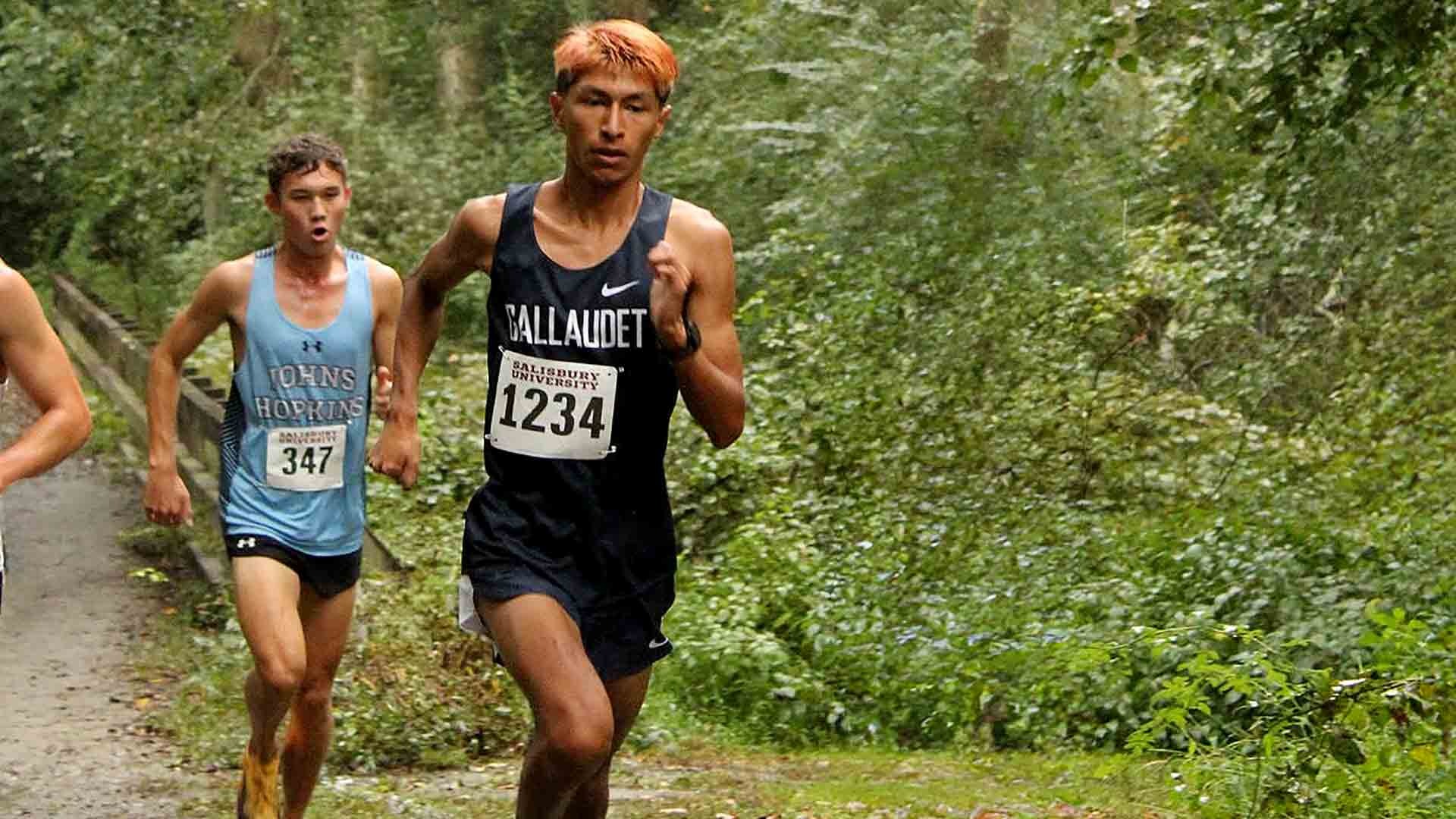Gallaudet men’s cross country runner Dylan Olmos races along a wooded section of the rain-soaked course during Saturday’s Don Cathcart Invitational in Salisbury, Maryland.