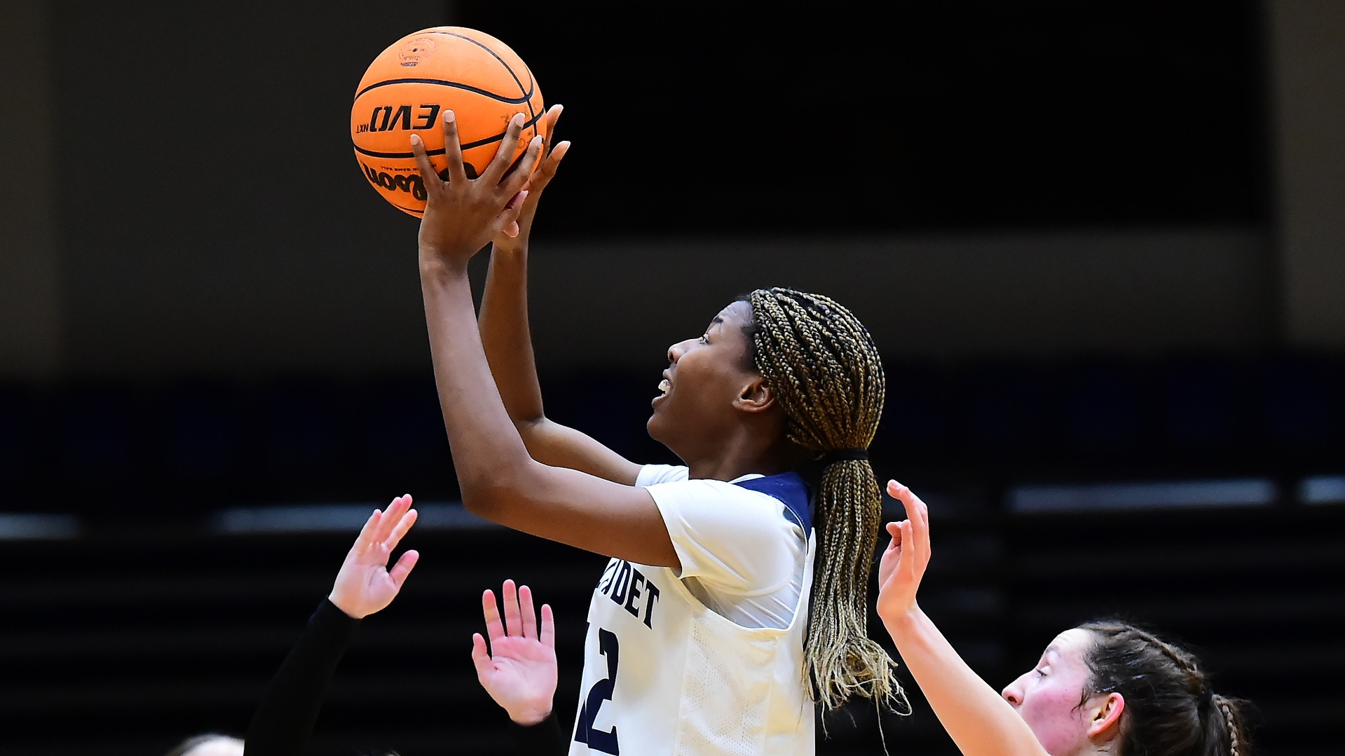 GU's women's basketball student athlete Kayla Debrow is attempting to layup in front of two defenders at Field House
