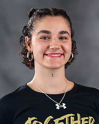 Anita Makhnyk 2026 Gallaudet women's flag football headshot. The Bison manager wears a black tshirt and looks towards the camera. A gray backdrop is in the background.