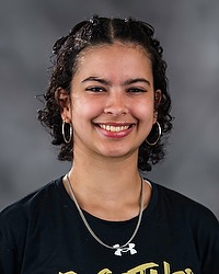 Valerie Salgado 2026 Gallaudet women's flag football headshot. The Bison manager wears a black tshirt and looks towards the camera. A gray backdrop is in the background.