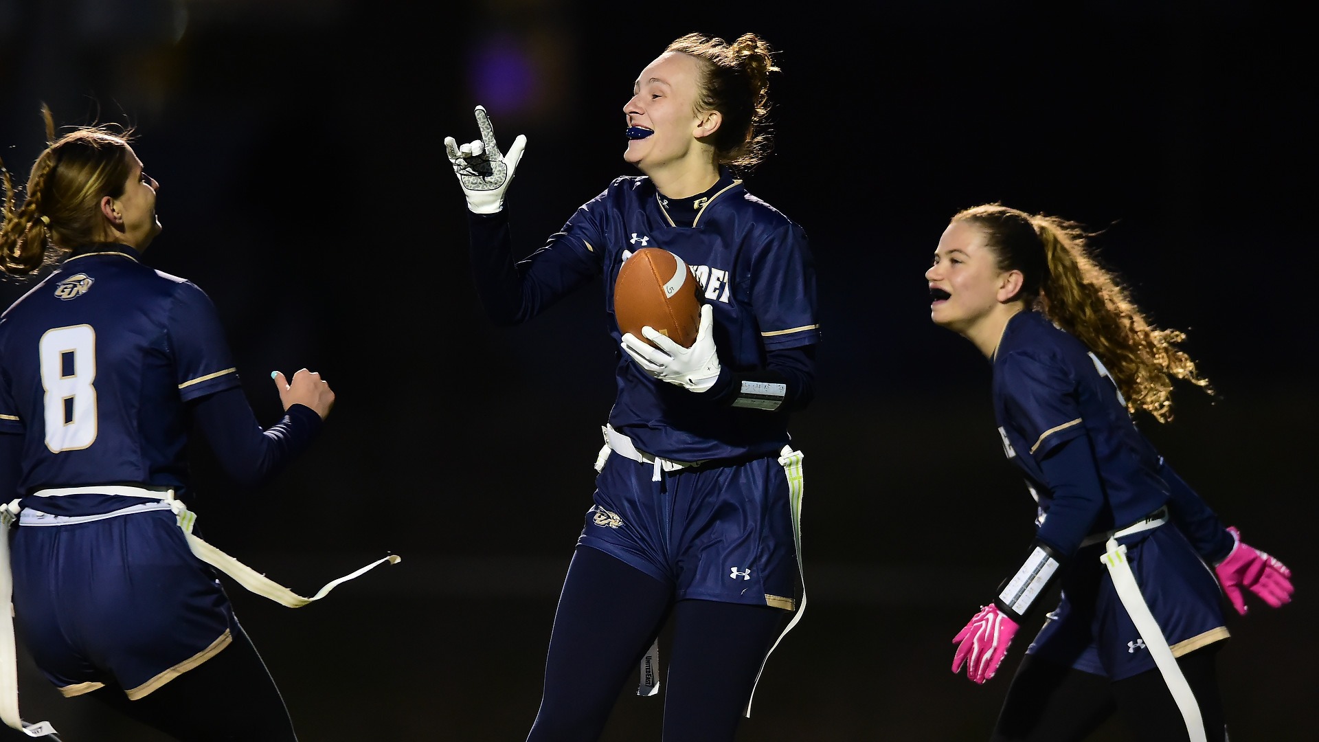 Gallaudet's Shaelyn Johnson celebrates a touchdown during a night game at Hotchkiss Field. 