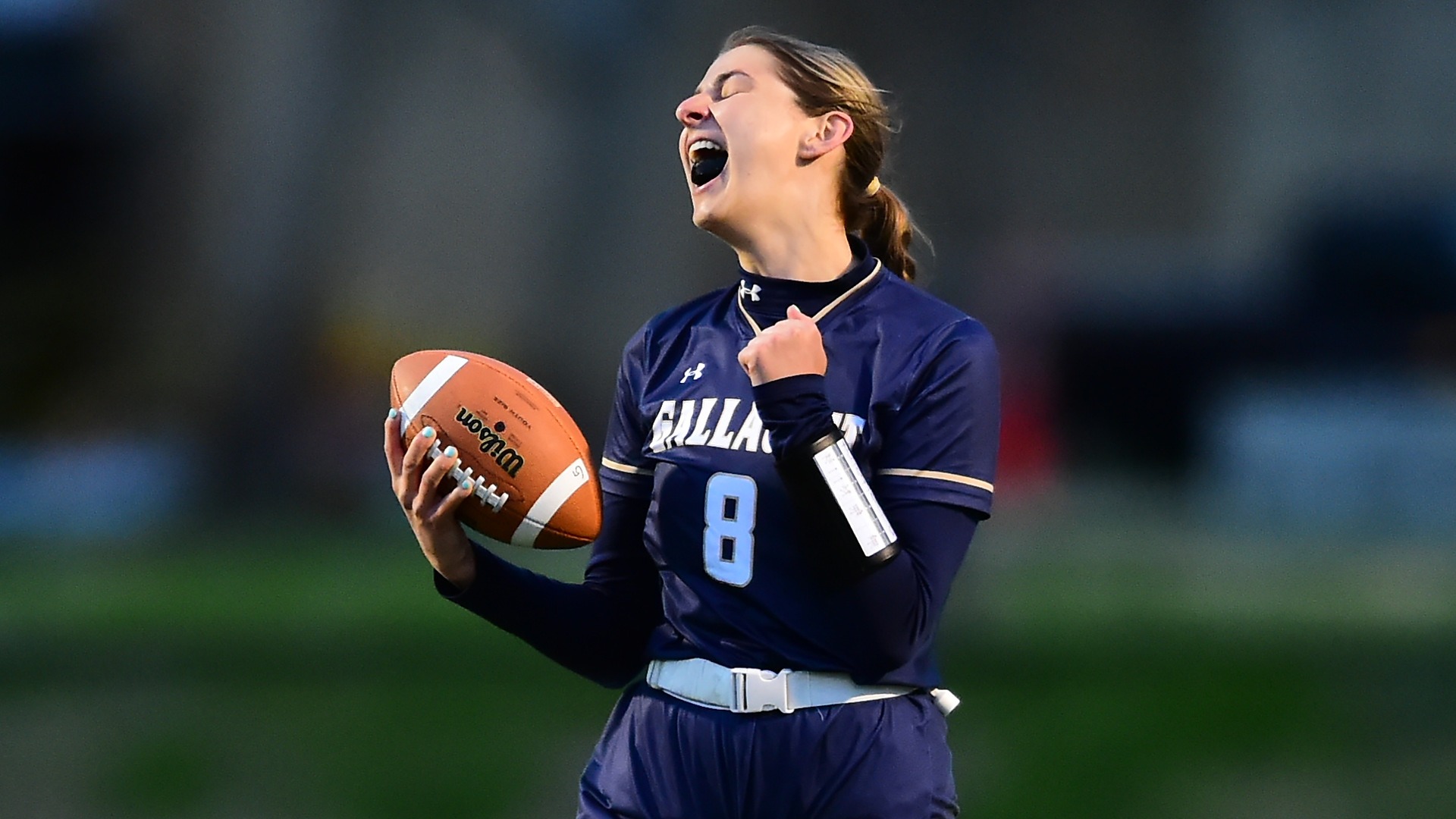Gallaudet women's flag football quarterback Gianna Visco celebrates a touchdown during a home game on Hotchkiss Field. 
