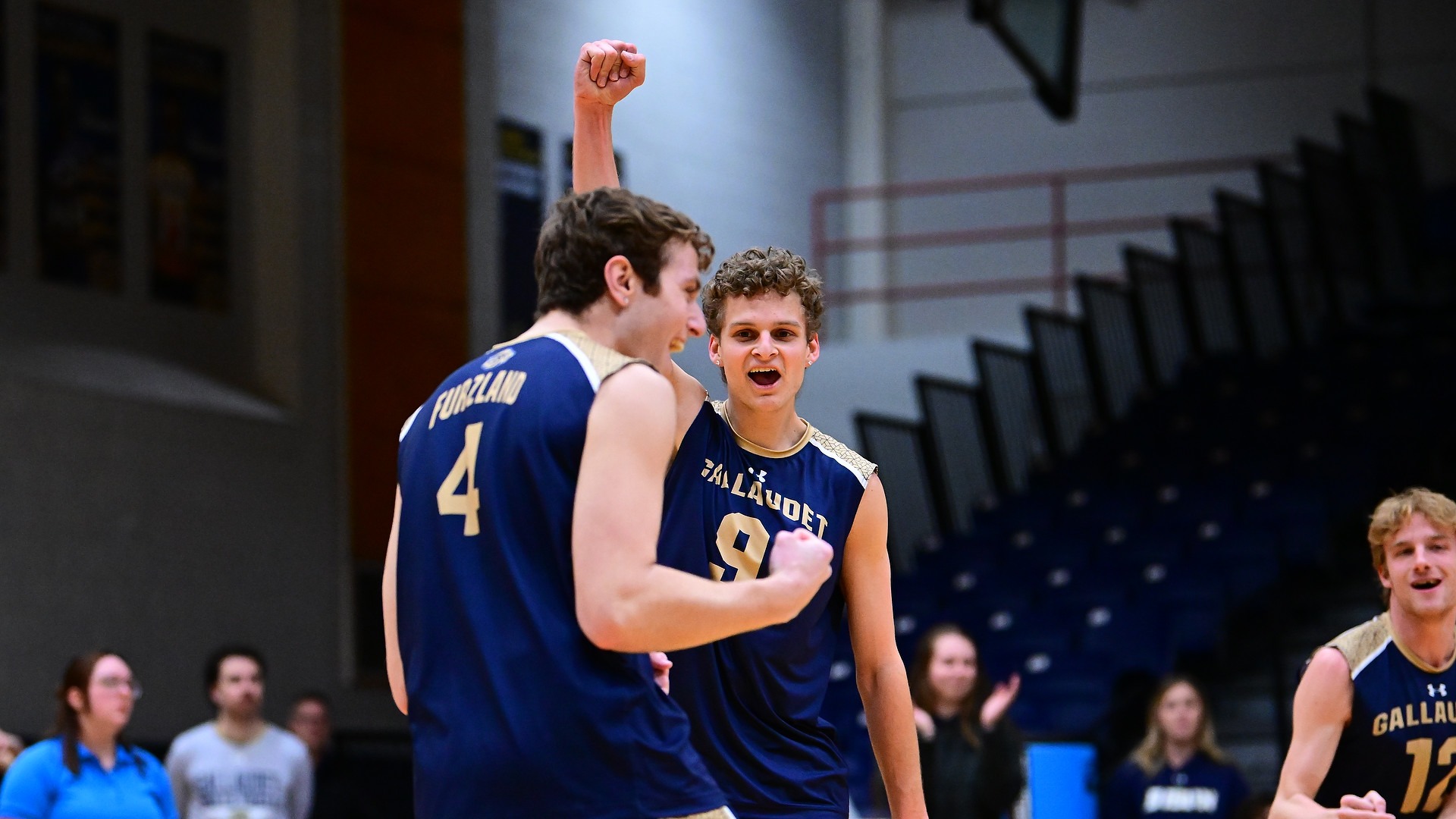 Gallaudet men's volleyball players Zachary Bippus and Tyler Furzland celebrate a point scored in a home match in the Field House. 