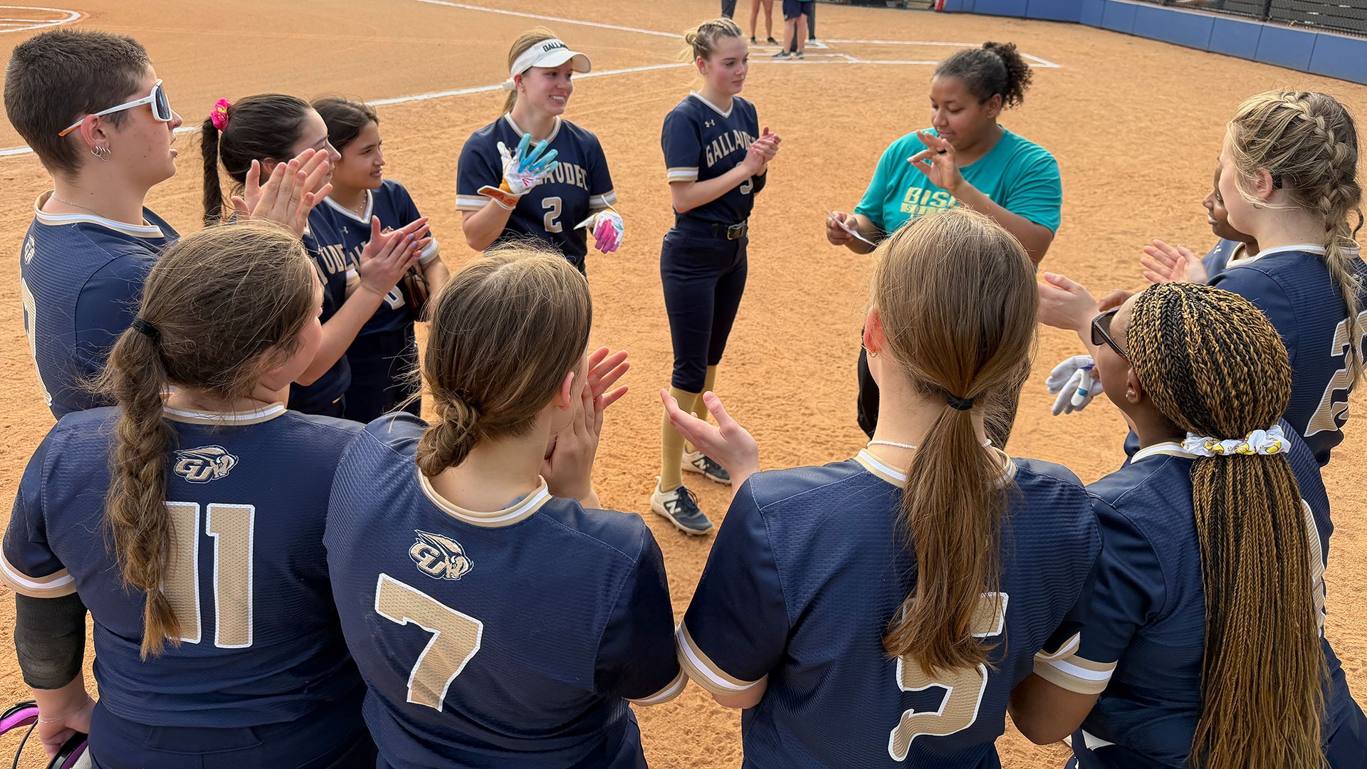 GU Softball team huddled before game begins at Triangle Softball Collegiate Tournament at Raleigh, NC