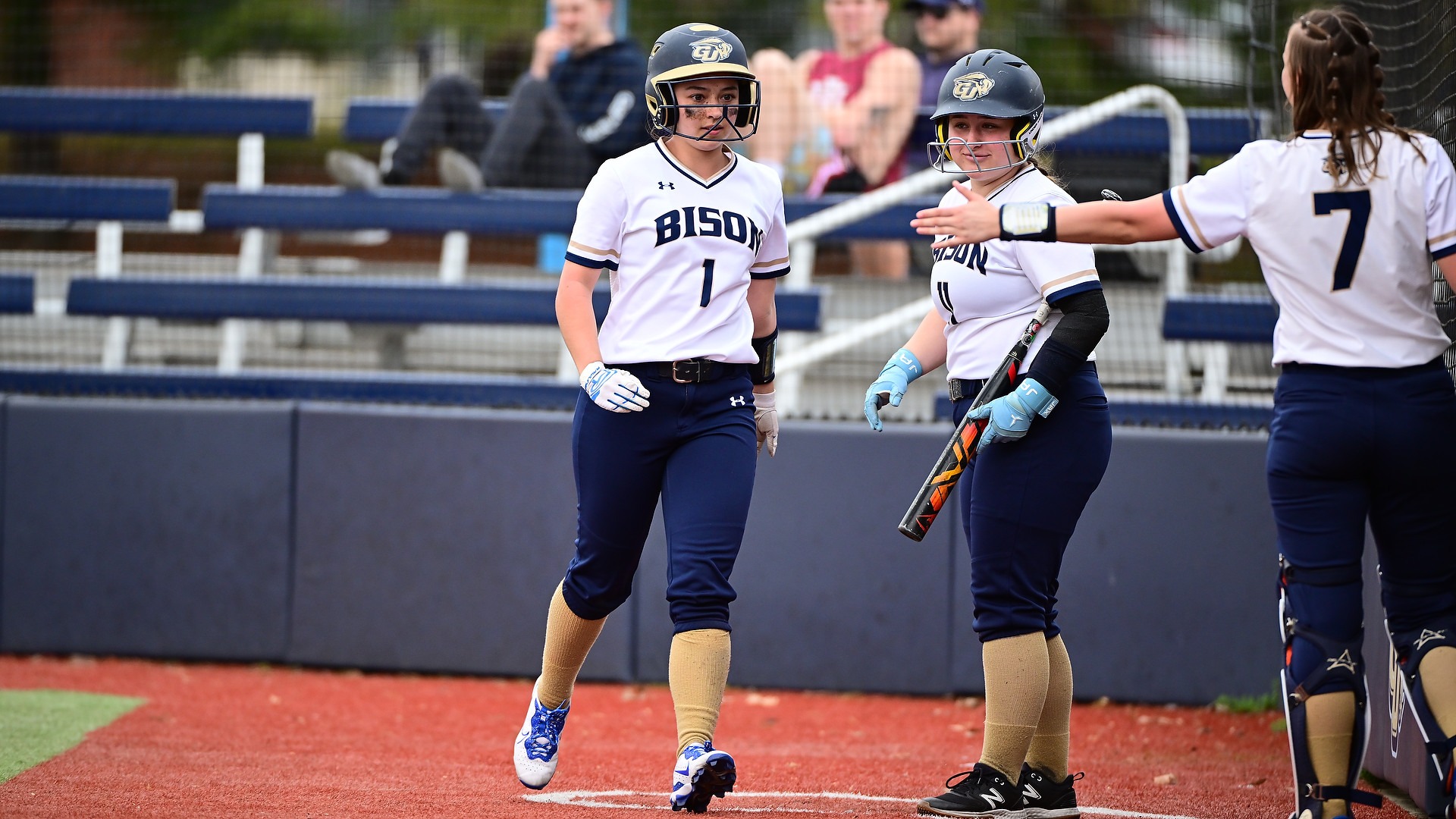 Howell is watching her teammate Brock to giving high five at GU Softball Complex in home game