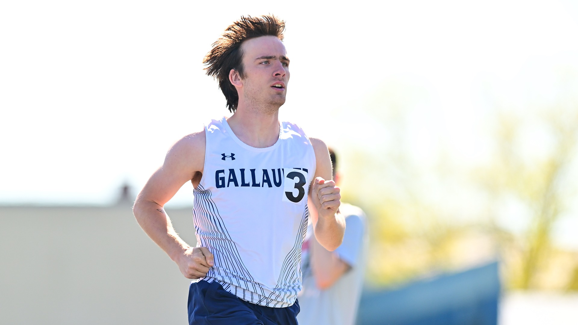Gallaudet's Joe Bryan runs on a sunny day around the Thomas O. Berg track on the campus of GU.