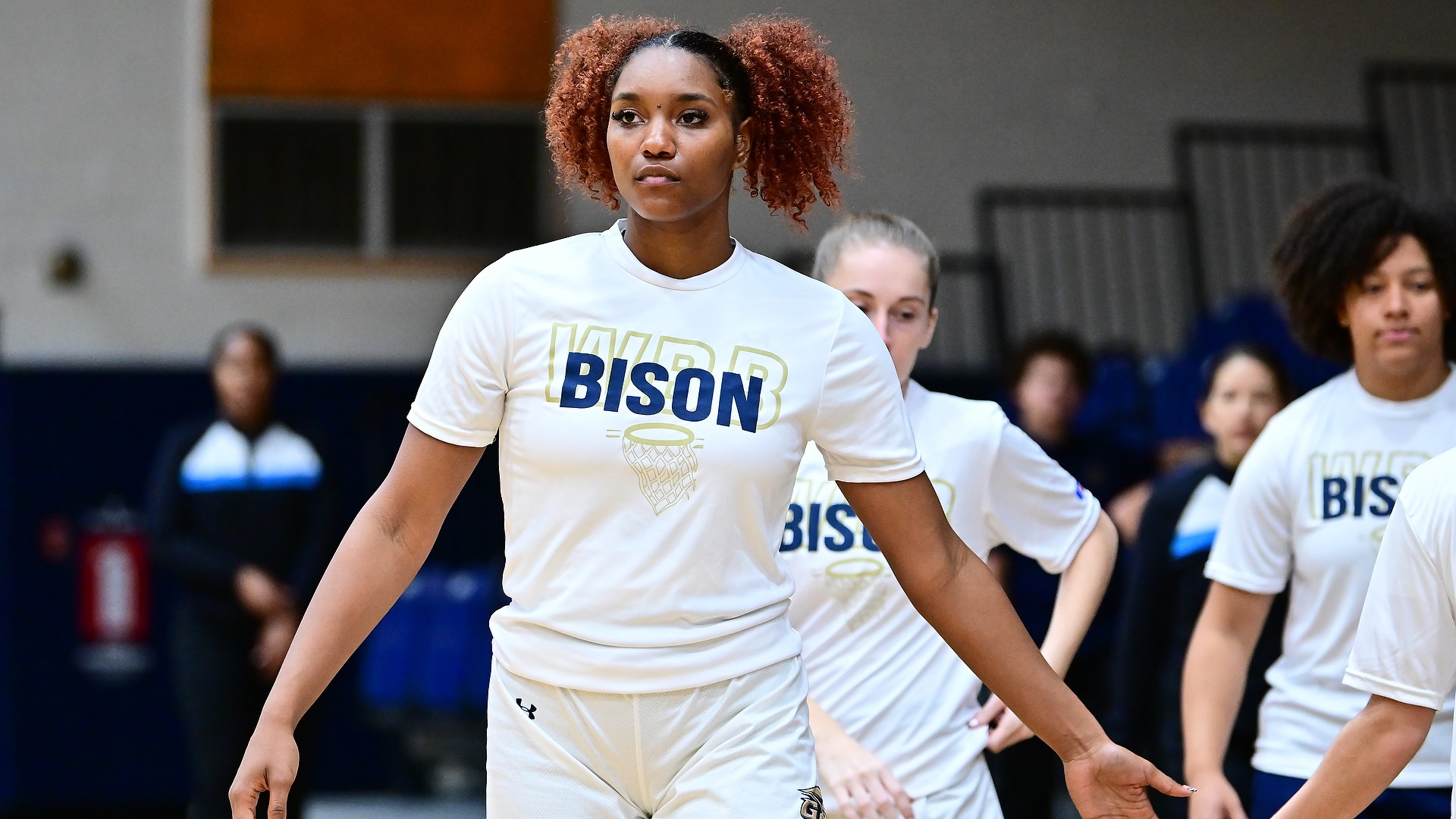 Gallaudet women's basketball player Natalie Greene stands in line during basketball warm ups during a home game.