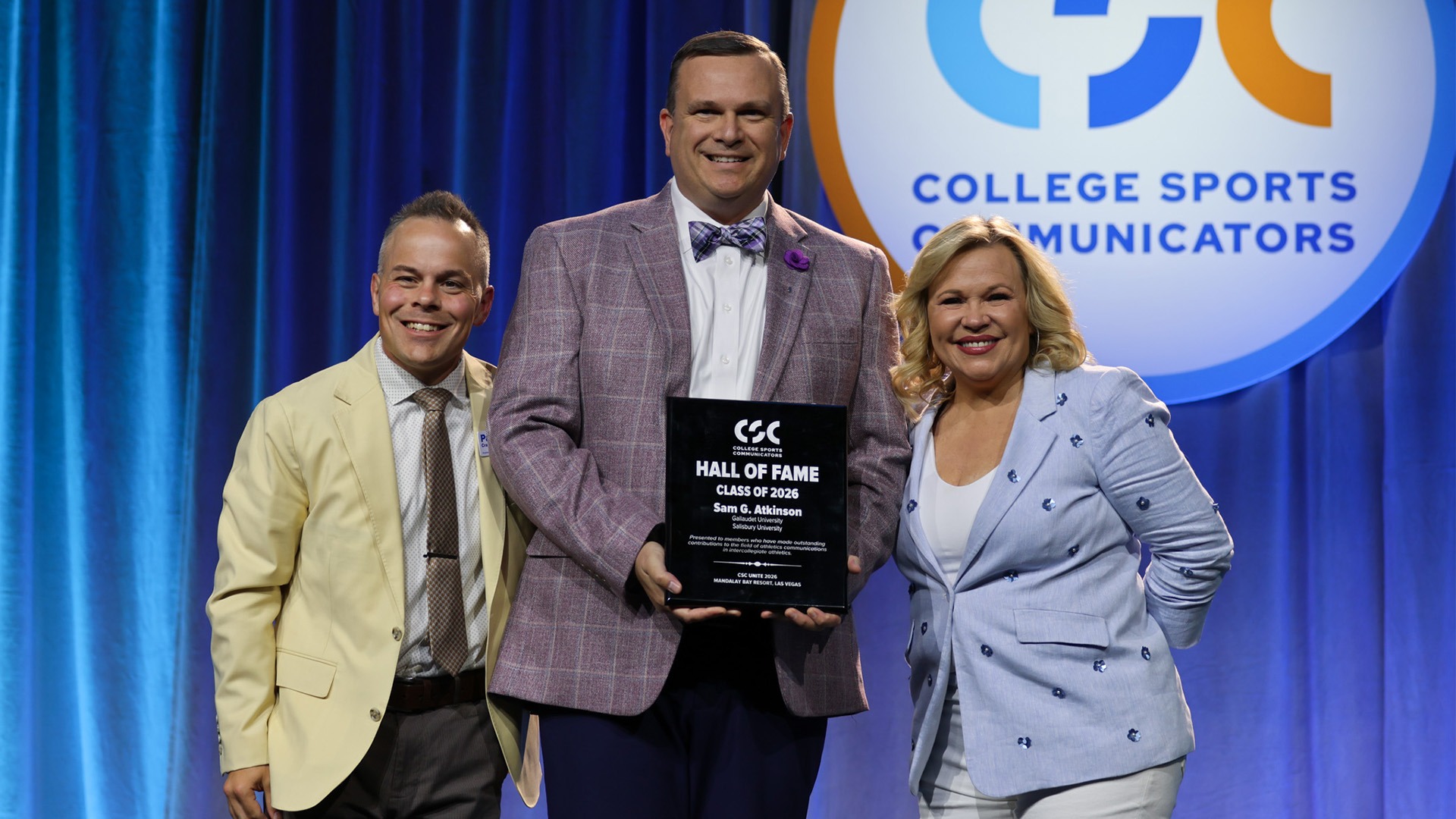 A group picture of Sam Atkinson recieved HOF plaque with CSC President Patrick Crawford and ESPN Broadcaster Holly Rowe at Mandalay Bay Resort in Las Vegas 