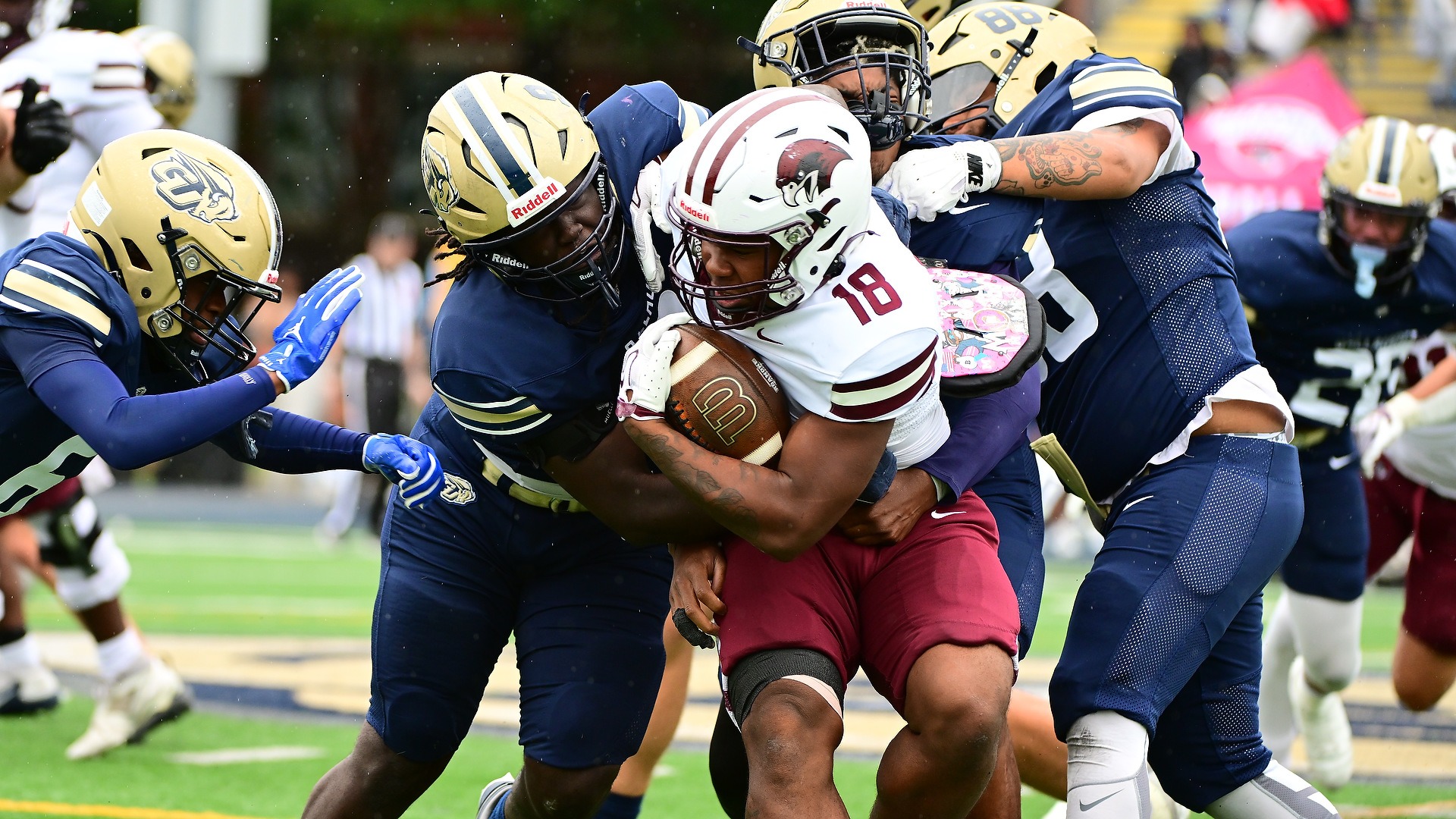 Gallaudet defender Lawrence Rivers (#9) wraps up Roanoke running back Trell Creasy (#18) as several Bison defenders converge to make the tackle during Saturday’s game at Hotchkiss Field.