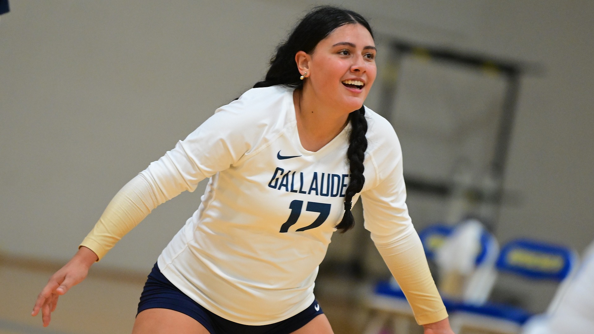 Gallaudet women’s volleyball player Adriana Jimenez Bonilla (#17) smiles while positioned and ready for the next play during a match.