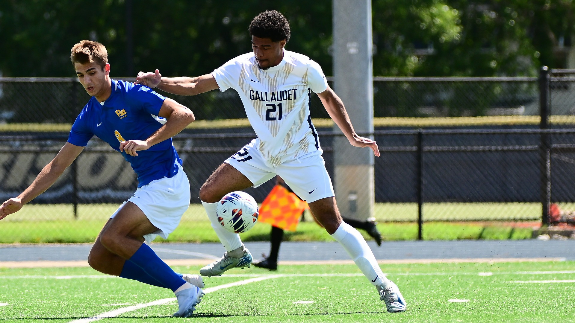 Gallaudet men’s soccer player Xavier De Leon (#21) battles a University of Pittsburgh-Bradford player for the ball during a sunny Sunday afternoon match at Hotchkiss Field.