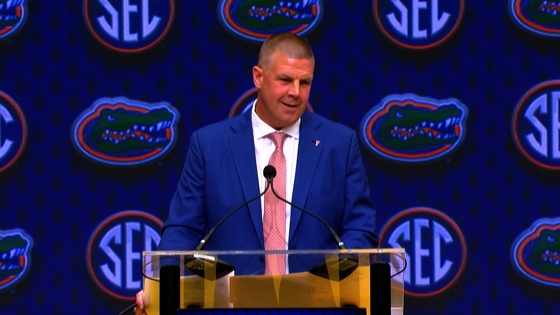 Coach Napier stands at a podium