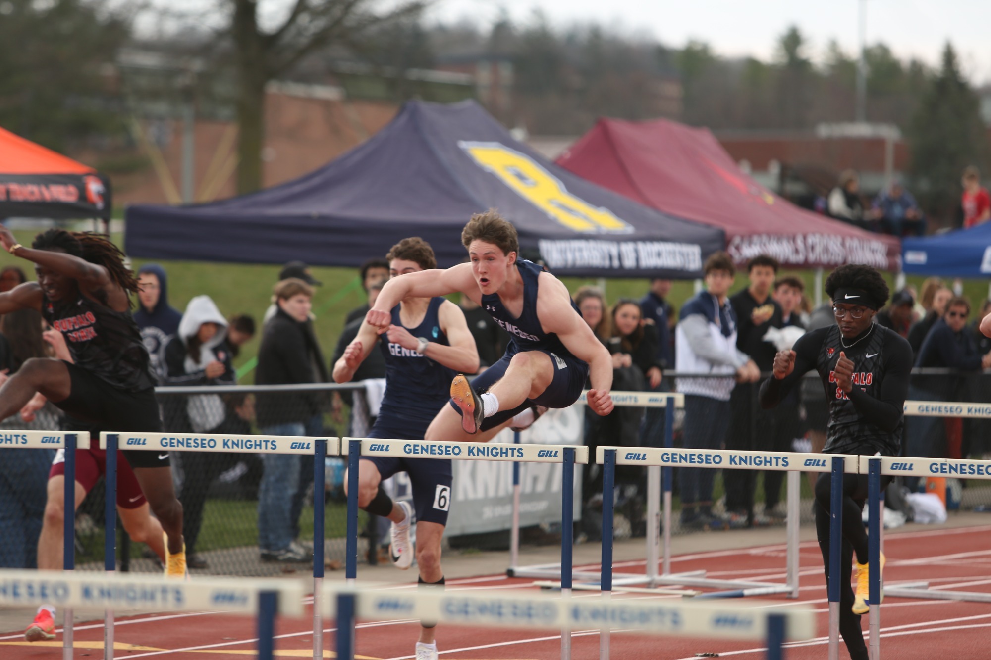 Men's Track and Field Athlete Going Over Hurdle
