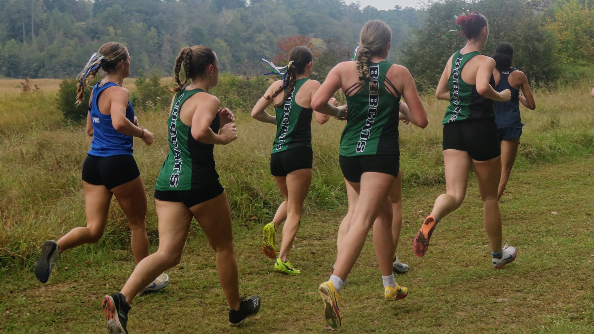 Women's Cross Country runners running