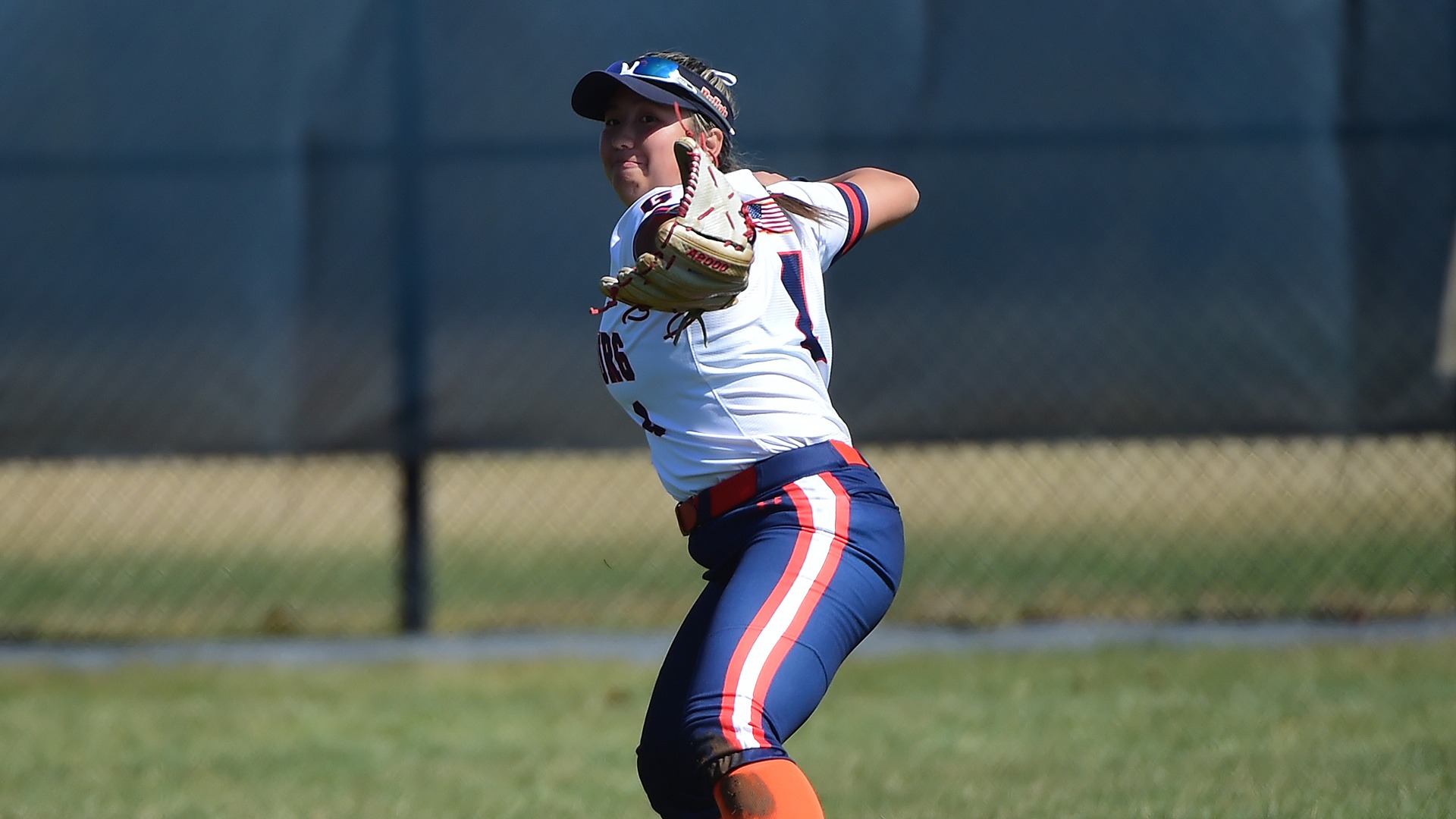 Zoe Brennan throws a ball from right field