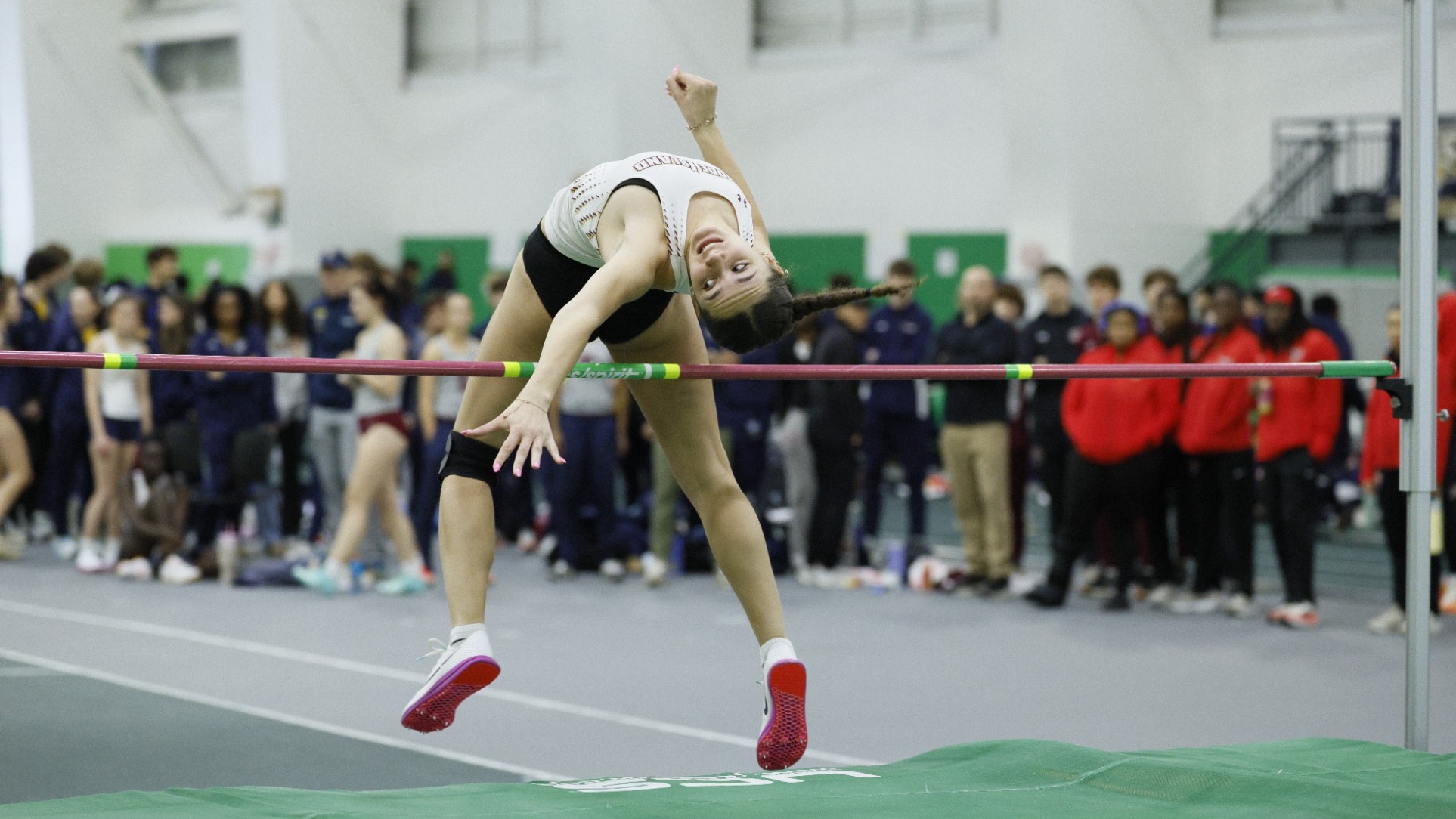 Shana Correia in high jump action during the 2026 Little East Championship