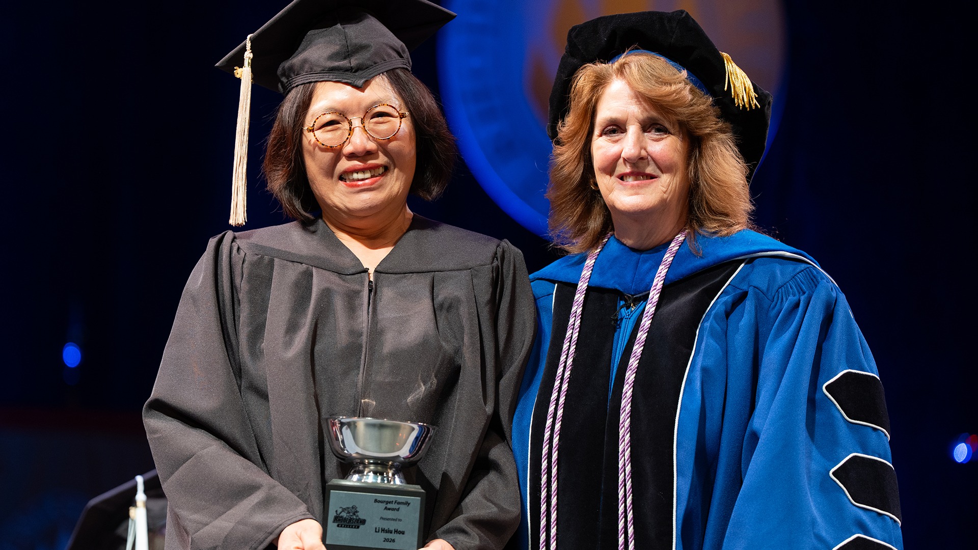 Li hsiu Hou Receives the Bourget Family Award from Nan Griffin at Cap and Gown Day