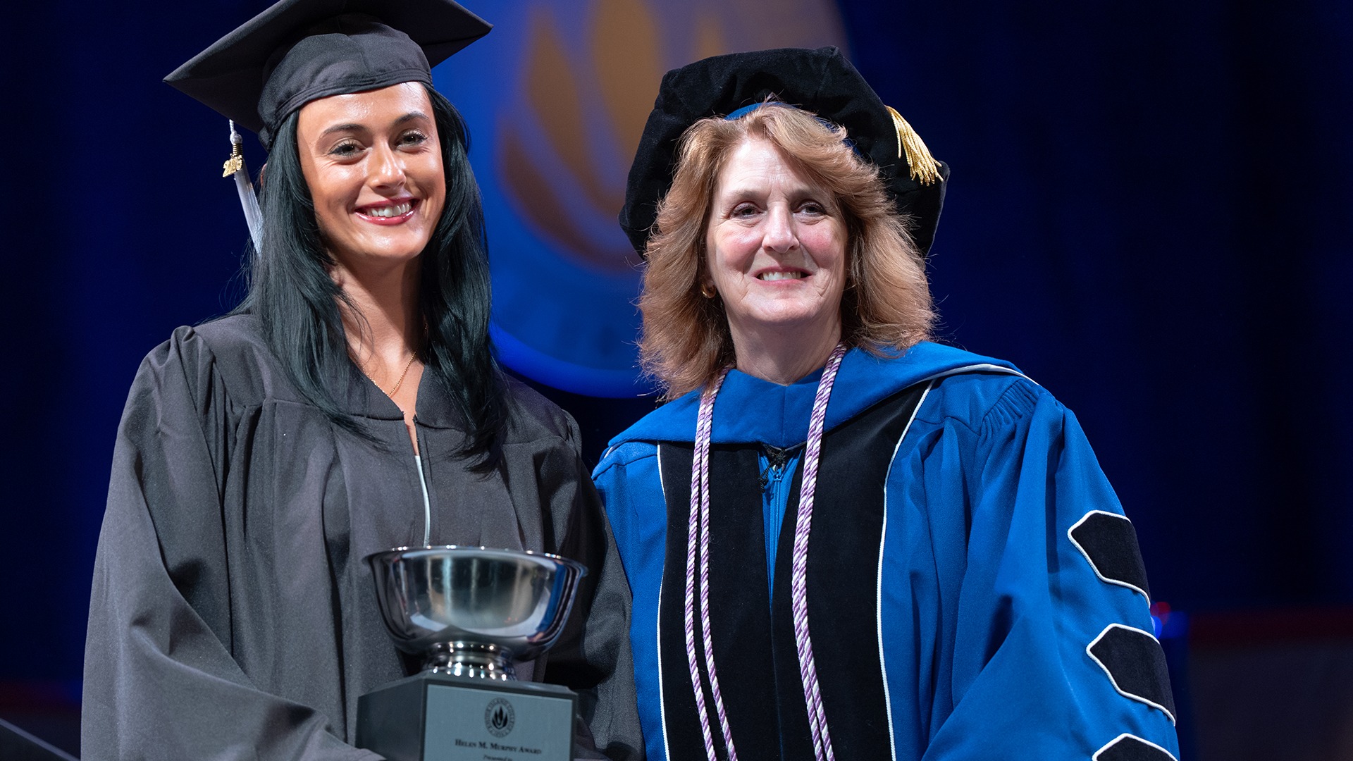 Haley Oliver receives the Helen M. Murphy Award from Nan Griffin at Cap and Gown Day