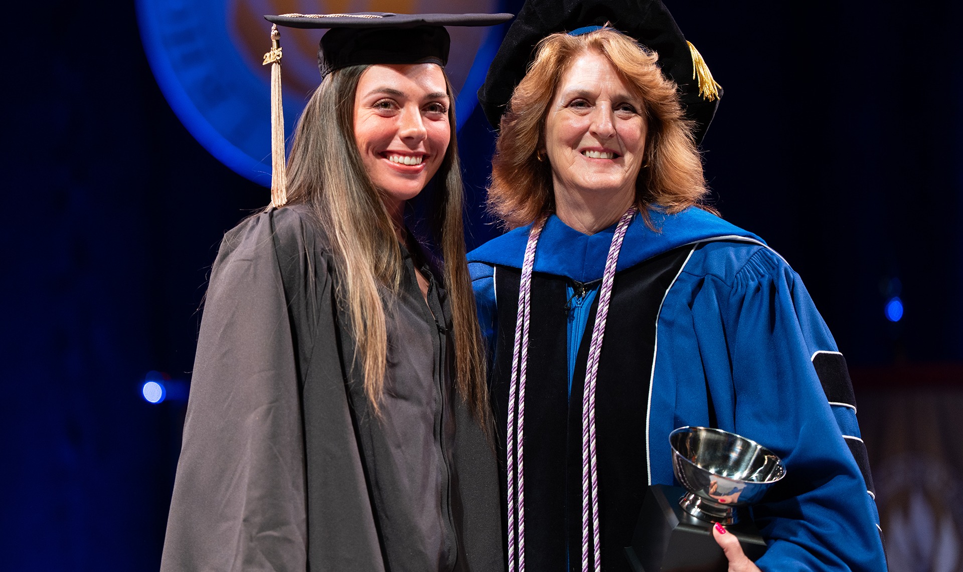 Noelle Simmons receives the Helen M. Murphy Award from Nan Griffin at Cap and Gown Day
