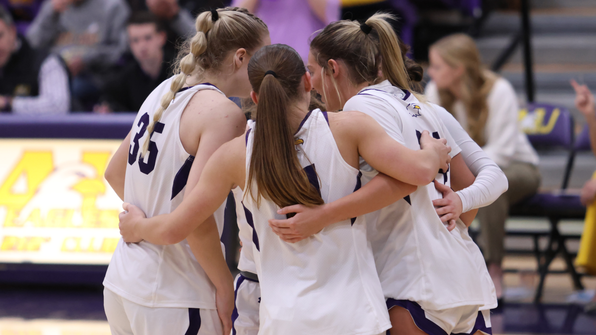 2025-26 WBB huddle action shot