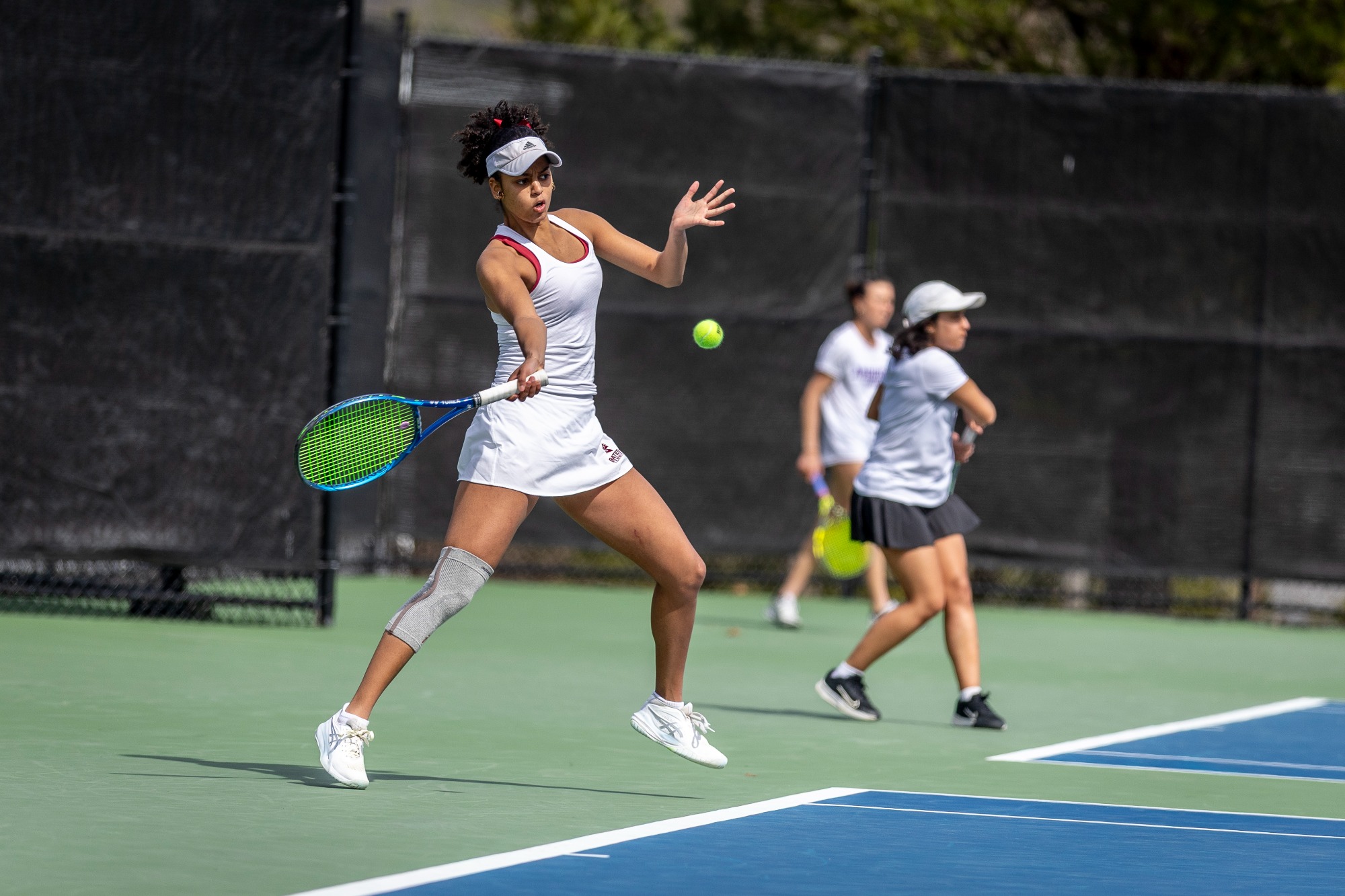 2026 April 12 -- Bates College Tennis Courts: Bates Womens Tennis matches against Amherst College on a warm, bright afternoon on the outside courts. This match includes seniors Grace LaFountain and Isabella Saul on the 