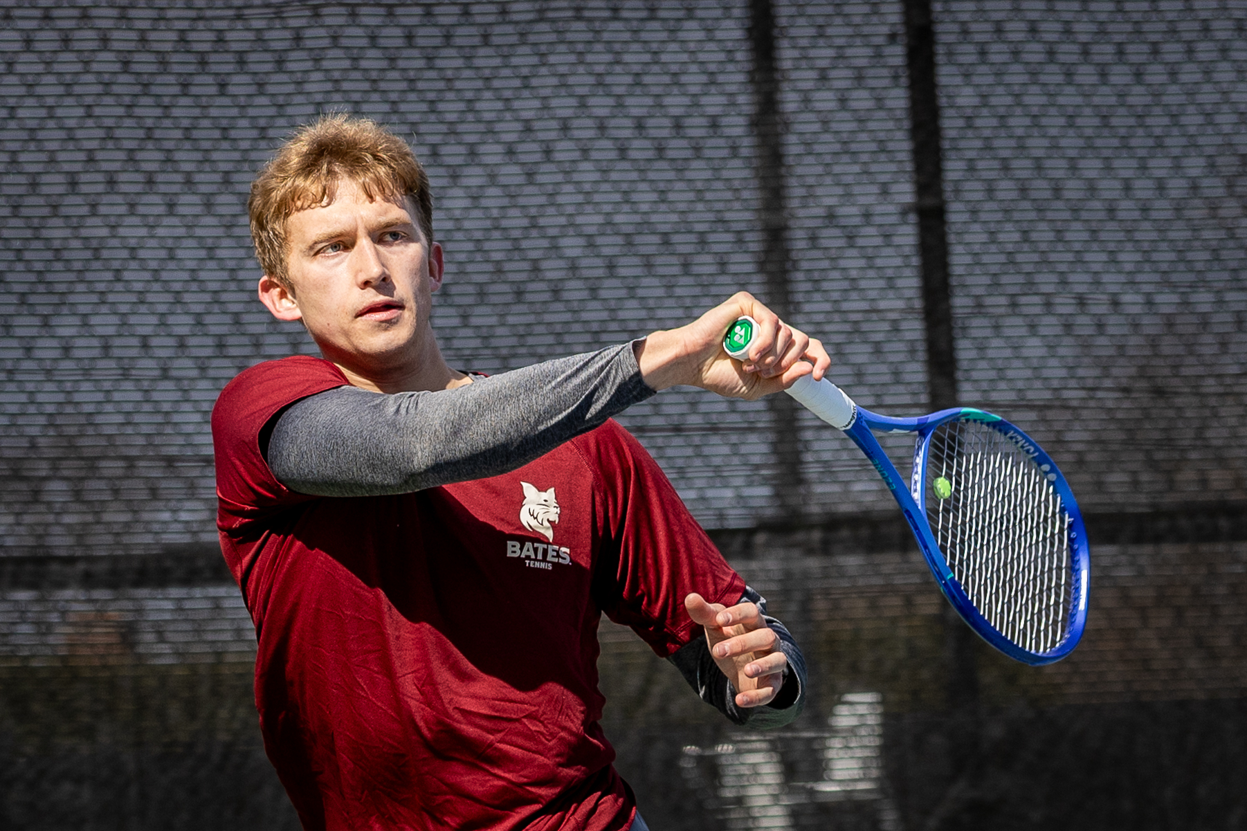 Bates mens tennis plays against Colby college outdoors at home on a bright chilly april afternoon. Sammy Weidenthal for Bates College