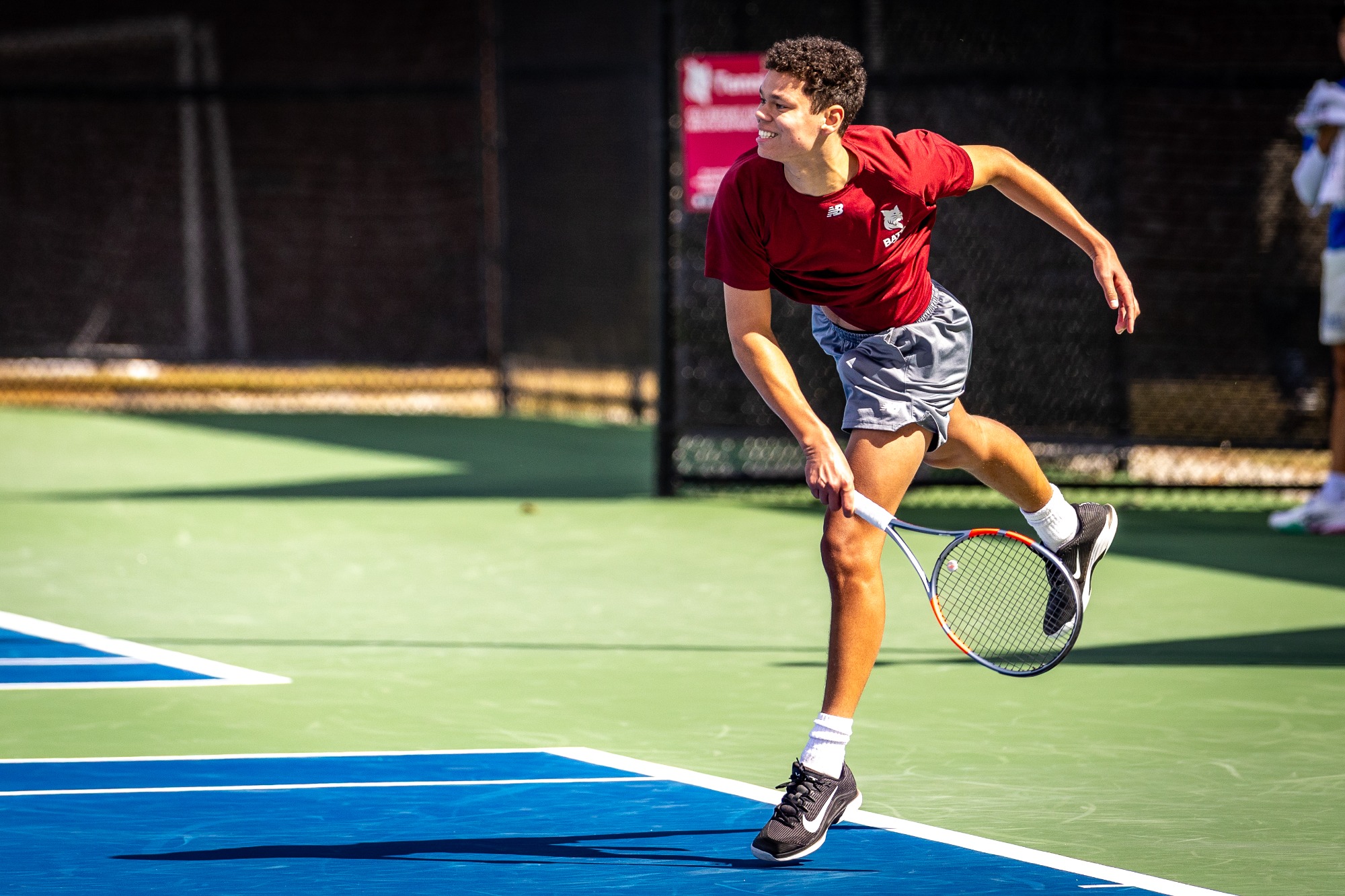 Bates mens tennis plays against Colby college outdoors at home on a bright chilly april afternoon. Sammy Weidenthal for Bates College