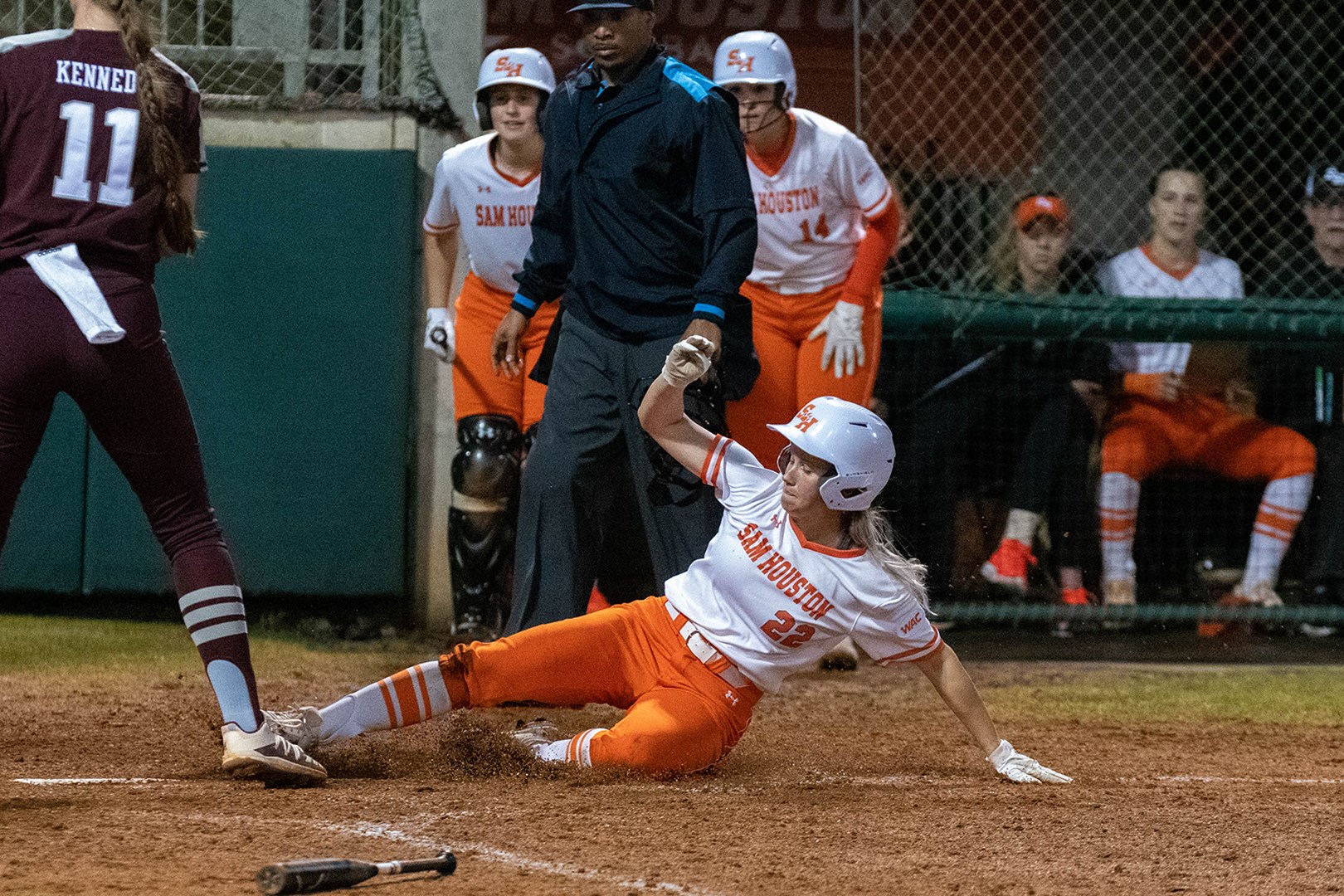 Sheridan Fisher slides home against the Aggies