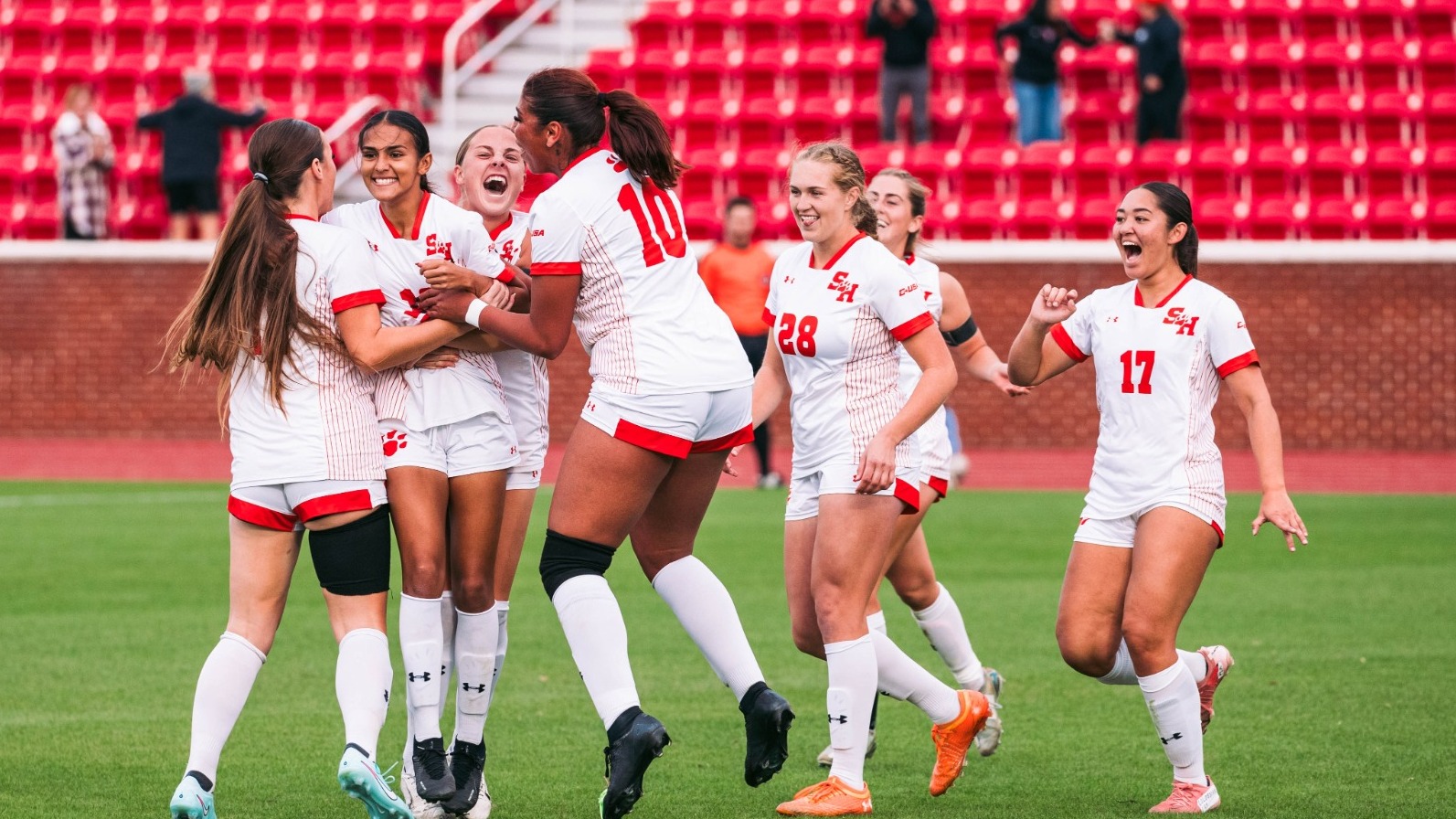Kelsey Villatoro is swarmed by her teammates after scoring the tying goal against Delaware at the CUSA Championship
