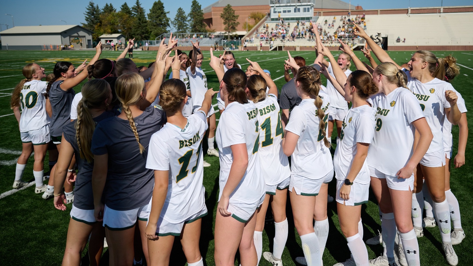 Women's Soccer Huddle Horns Up