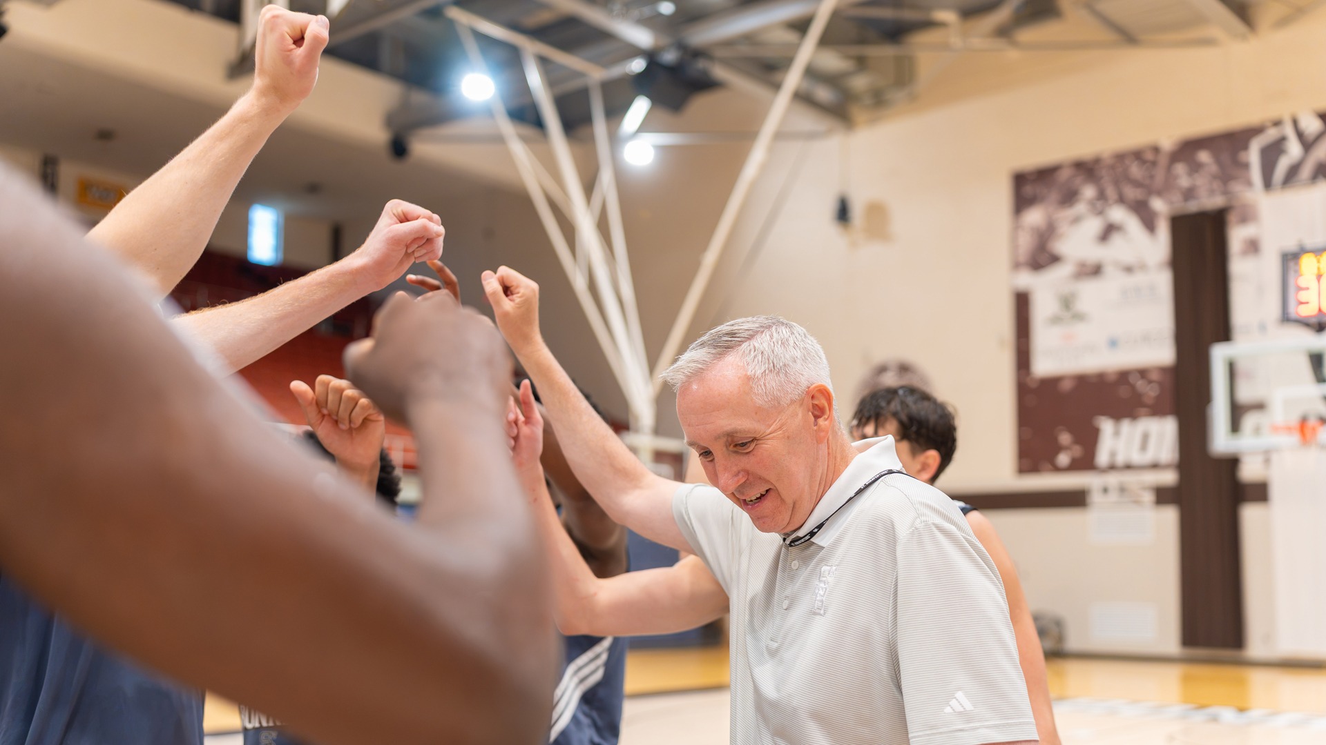 Coach MacDonald huddle at practice