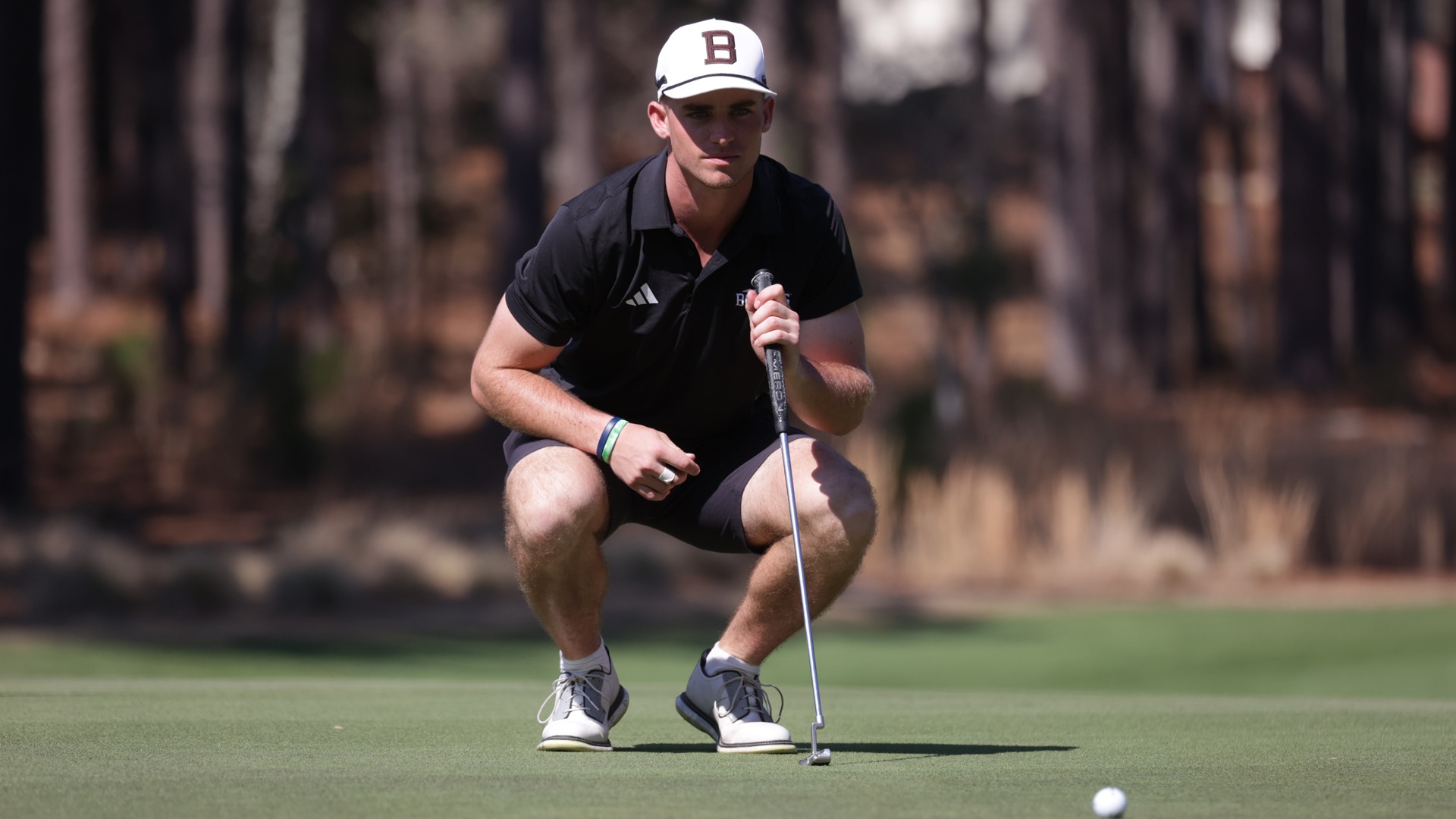 Gabe Williams lining up a putt