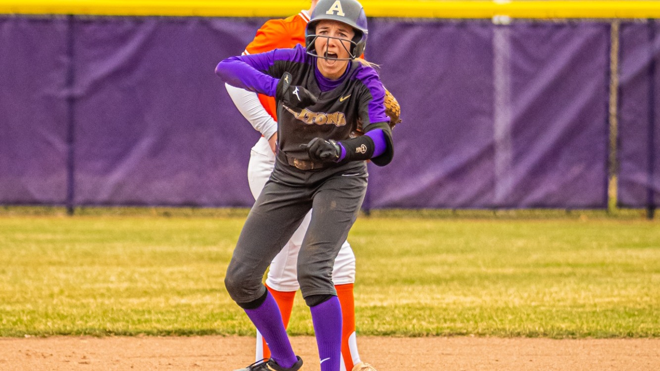 Elaina Braunscheidel celebrating after ripping a clutch RBI double