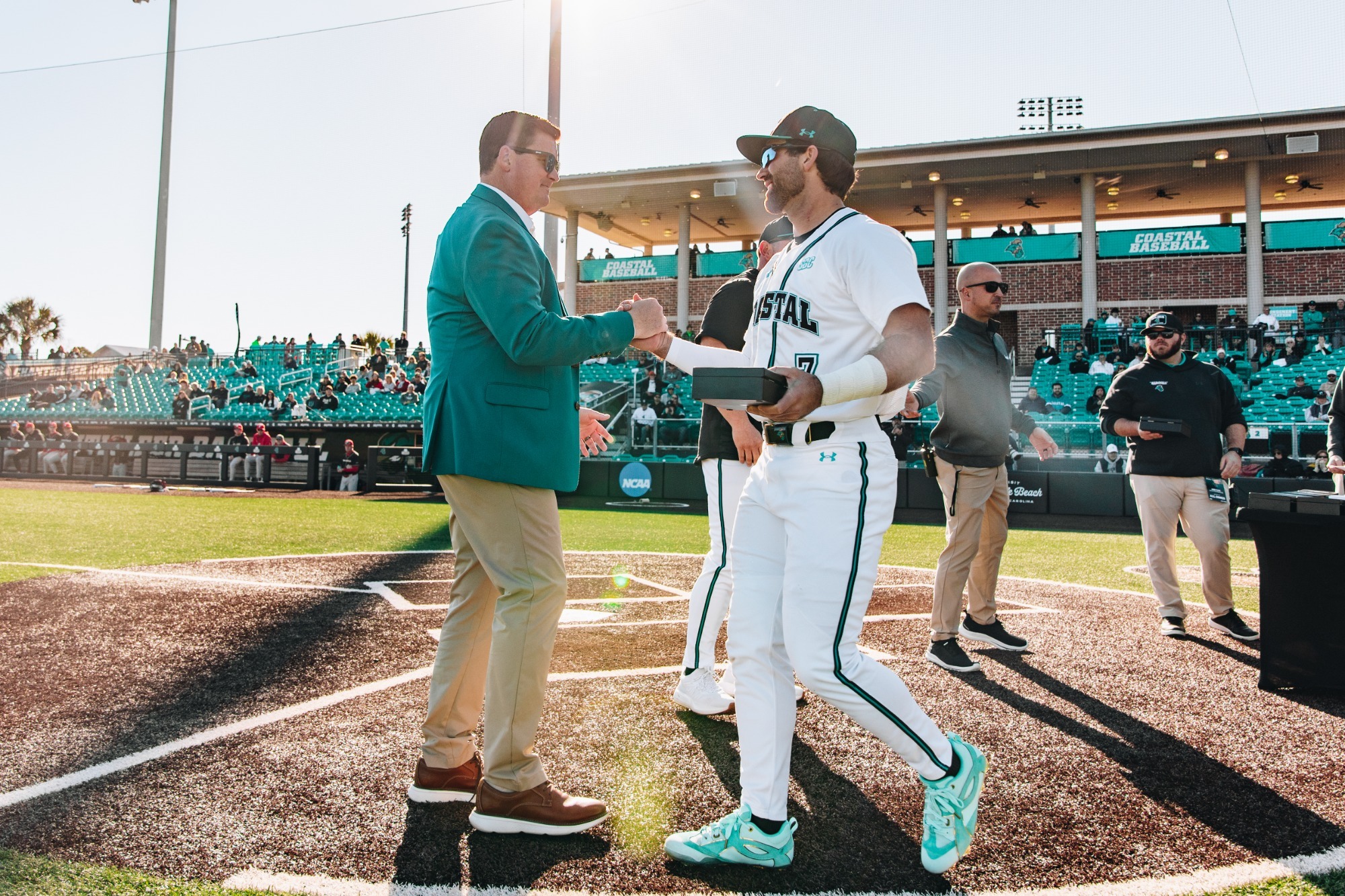 Kevin Schnall congratulates Blake Barthol on baseball opening day 