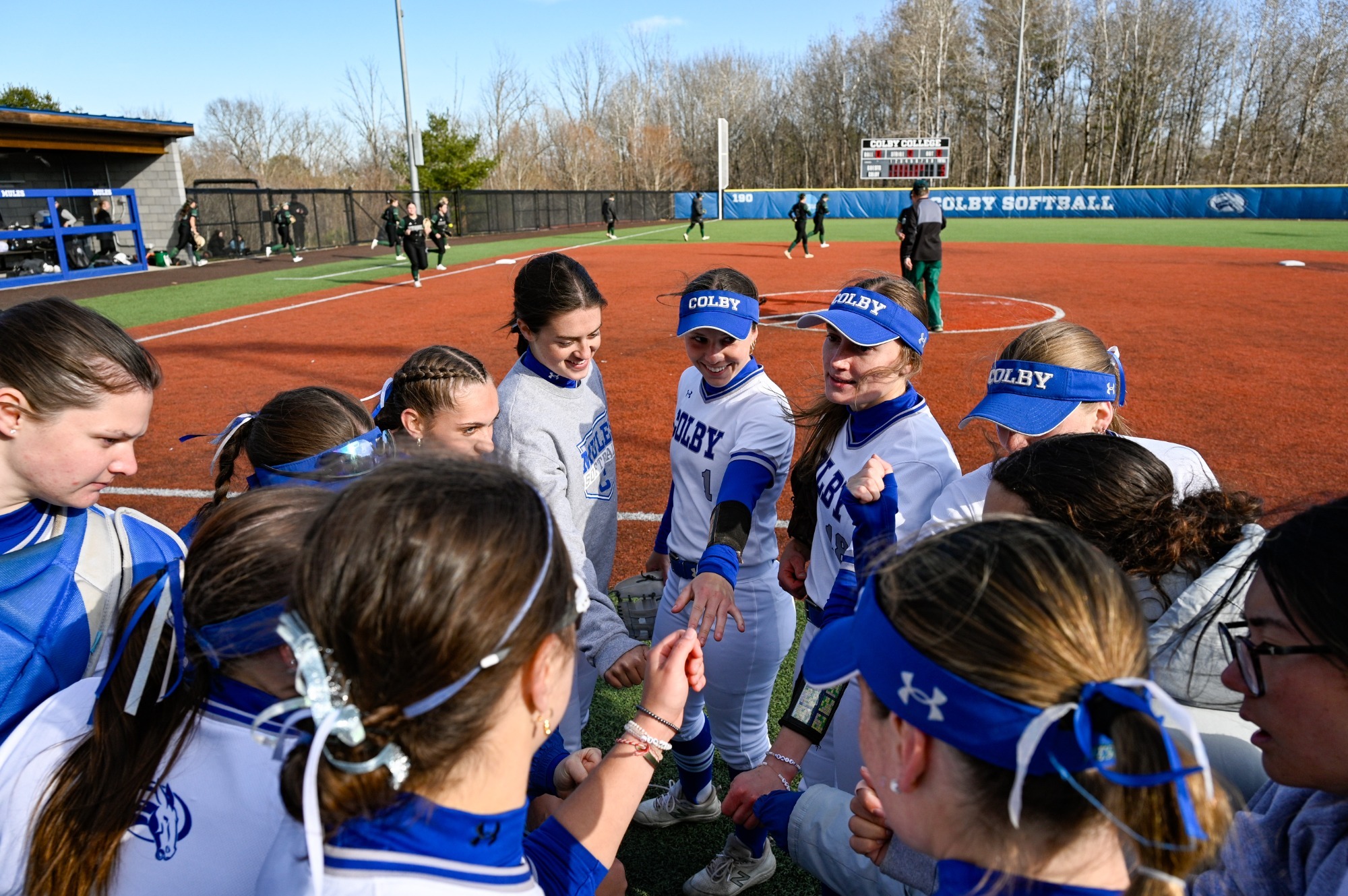 Softball team huddle vs. Husson 2026