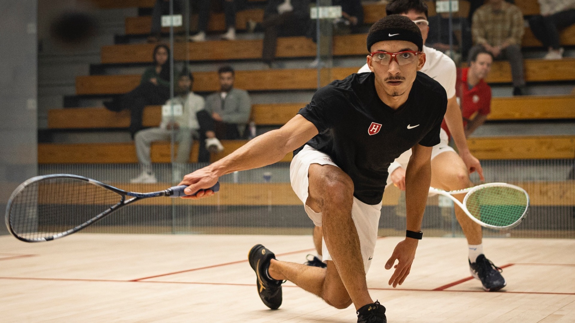 Omar Azzam returning a shot off the glass