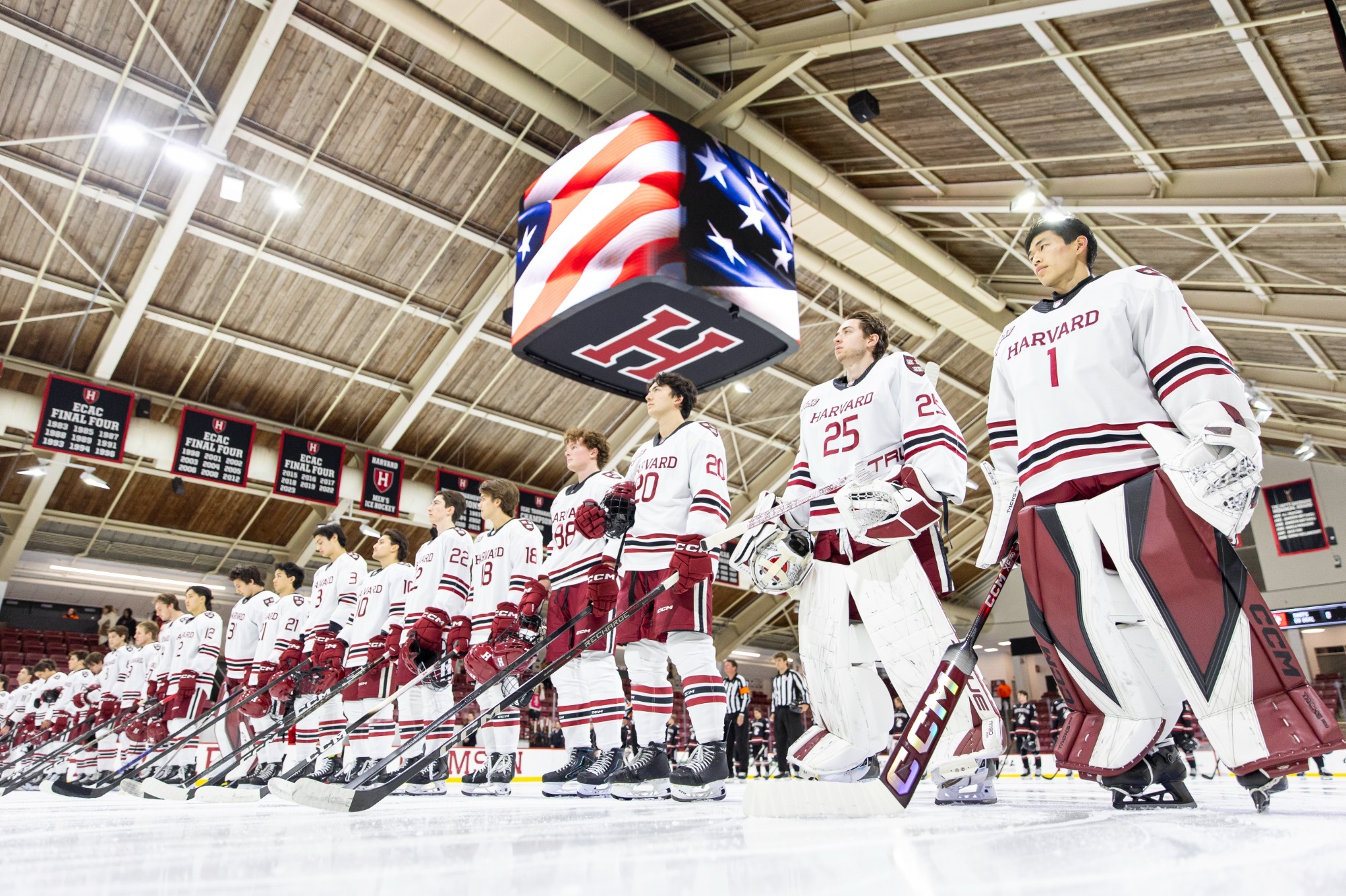 Harvard stands at the blue line during the national anthem.