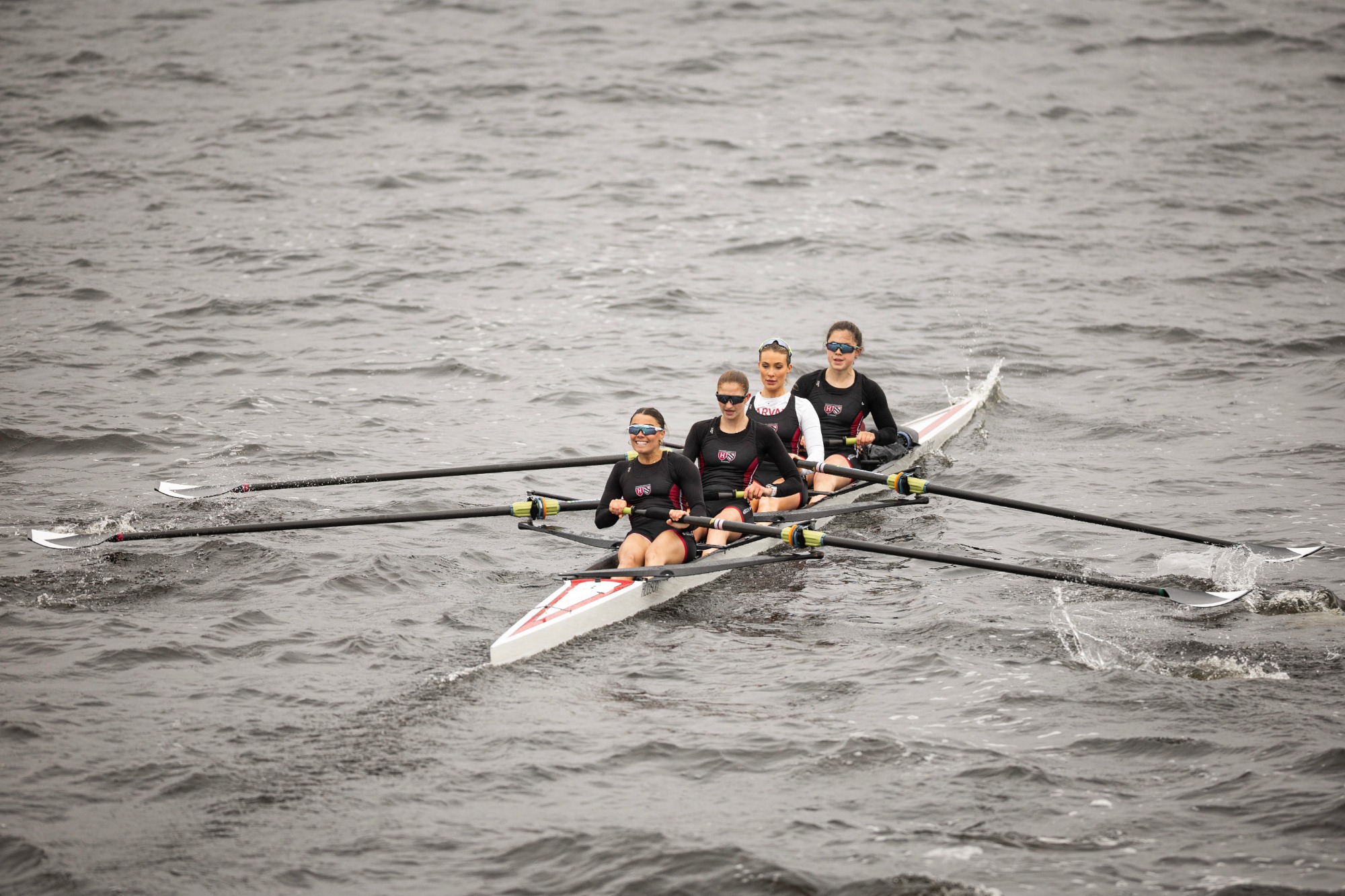 Women's lightweight rowing varsity four boat competes in the Beanpot on the Charles River.