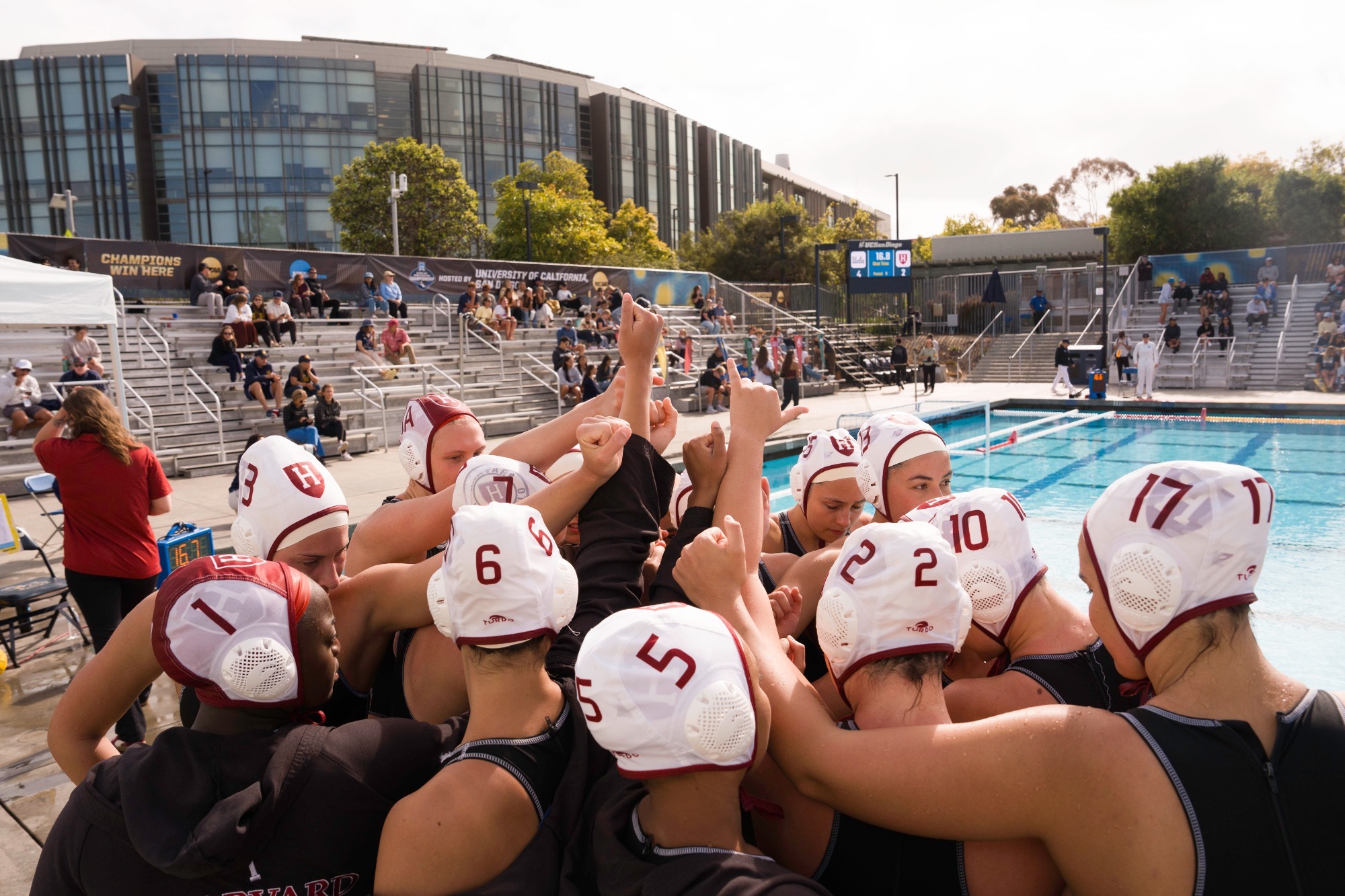 Women's water polo team huddle on the deck at the 2026 NCAA Championships.
