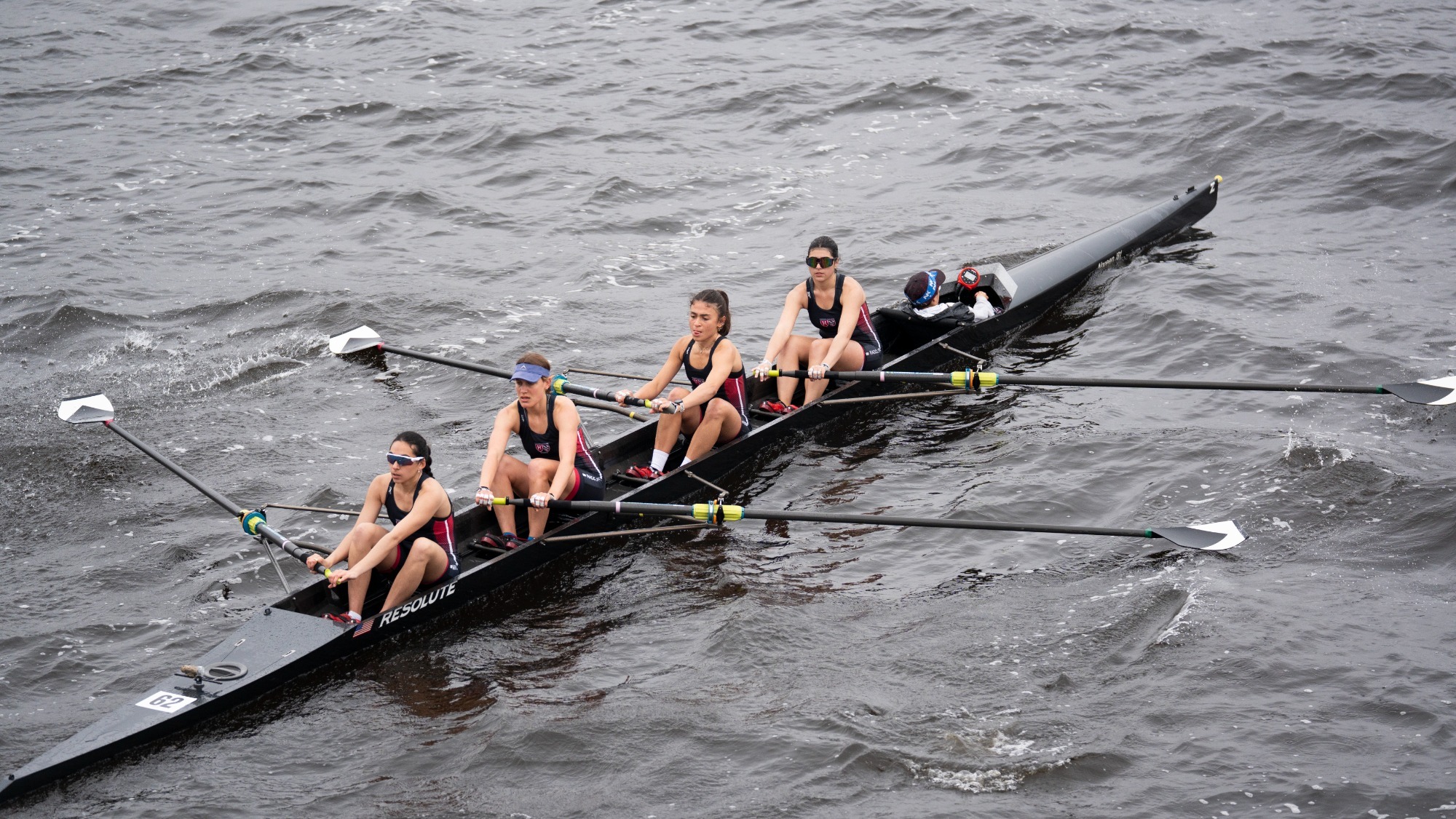 Varsity four rows on the Charles River.