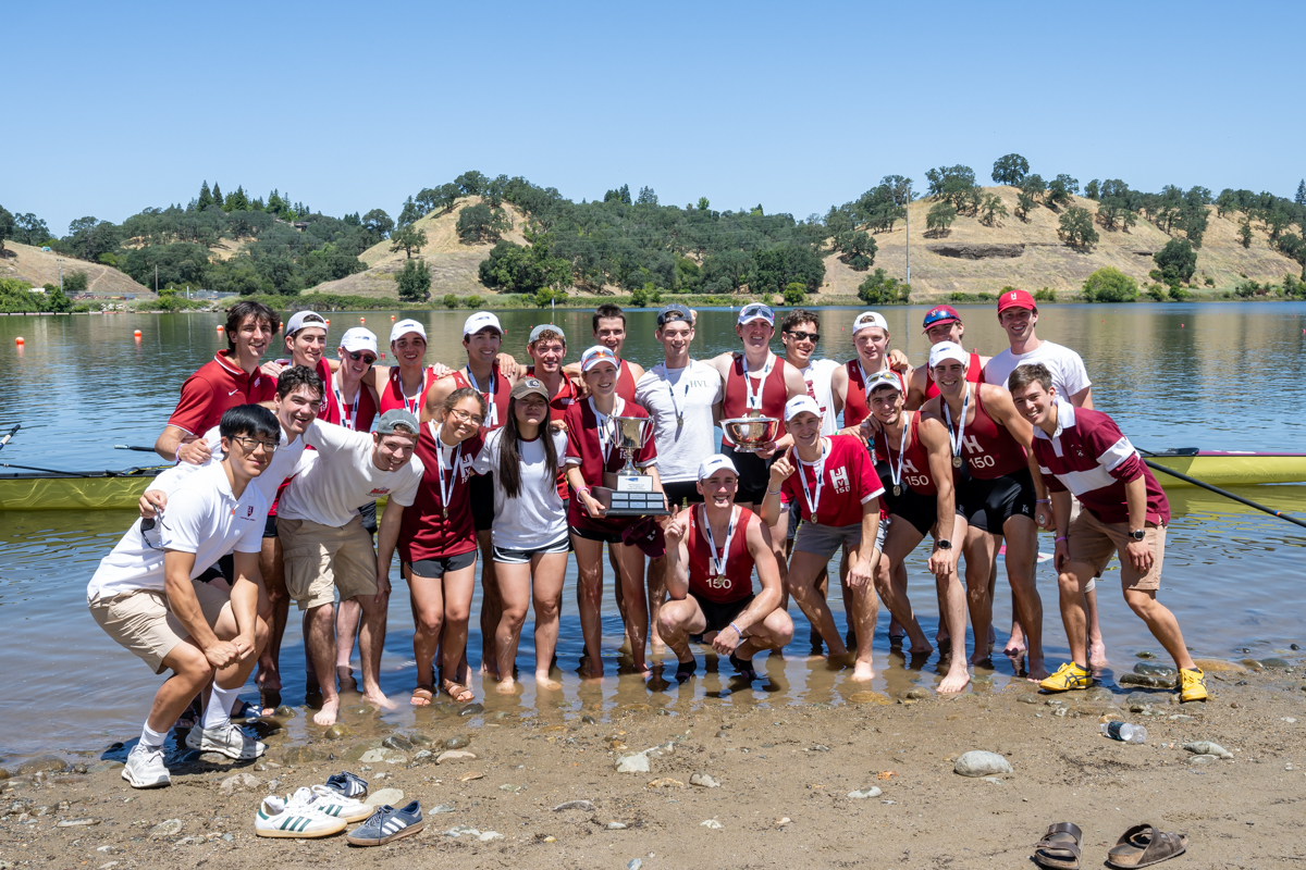 Harvard lightweight athletes and staff pose with championship hardware.