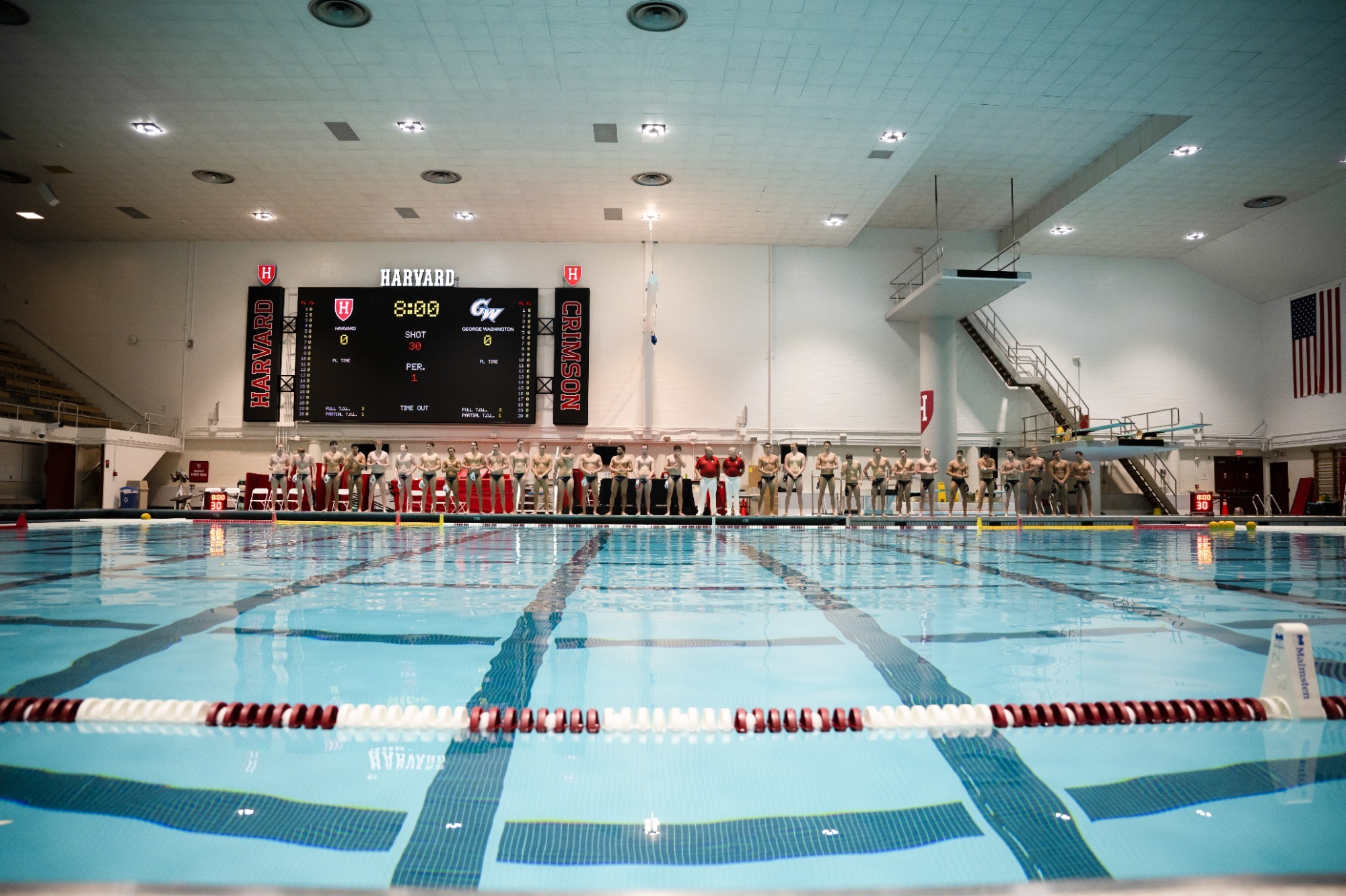 Harvard men's water polo lines up on the deck at Blodgett Pool prior to a 2025 match.