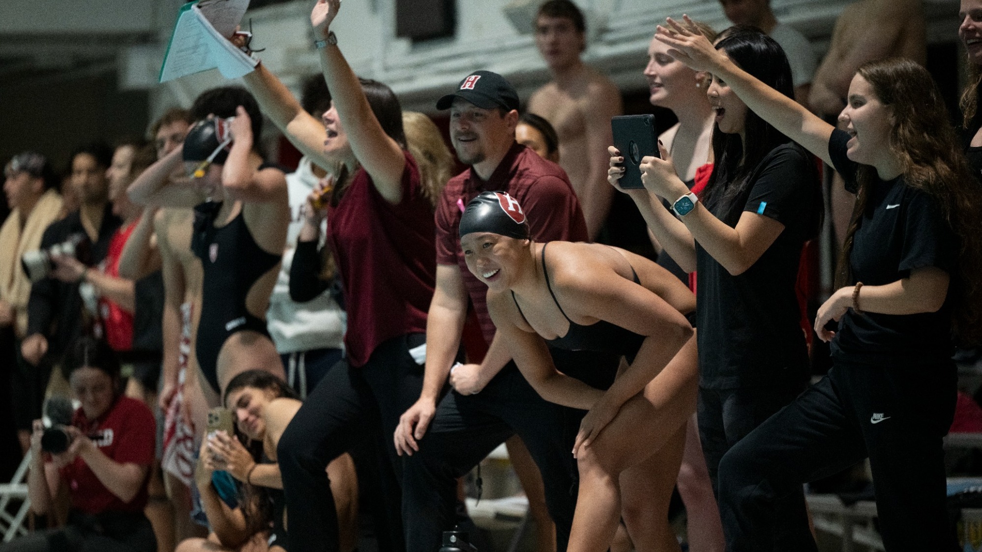 Harvard Women's Swimming and Diving on pool deck during competition