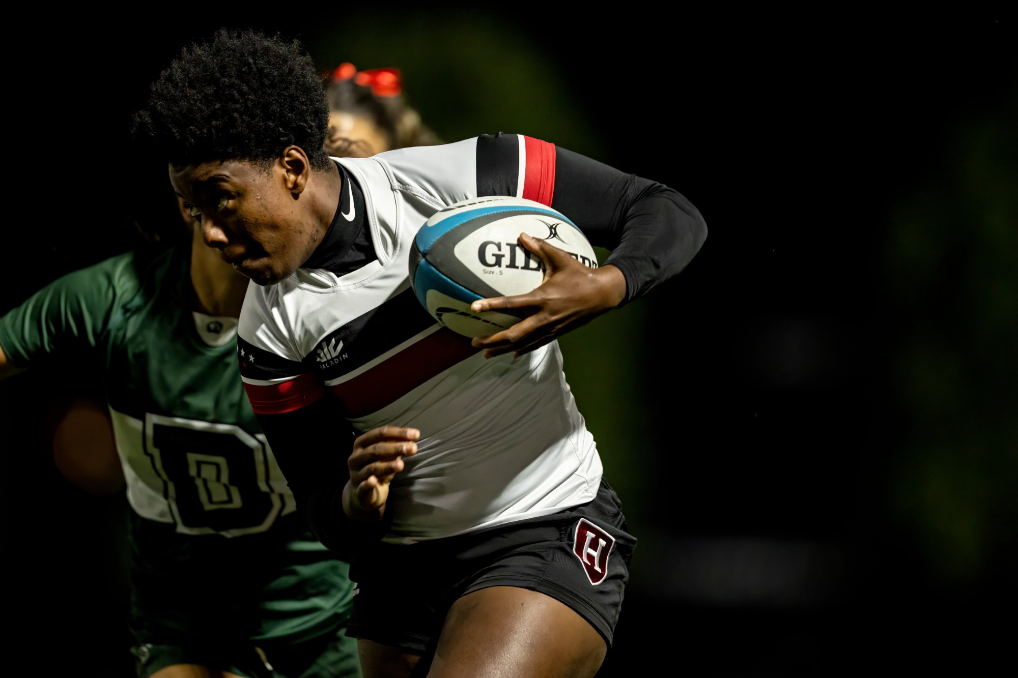 Harvard with the ball challenged by a Dartmouth defender.