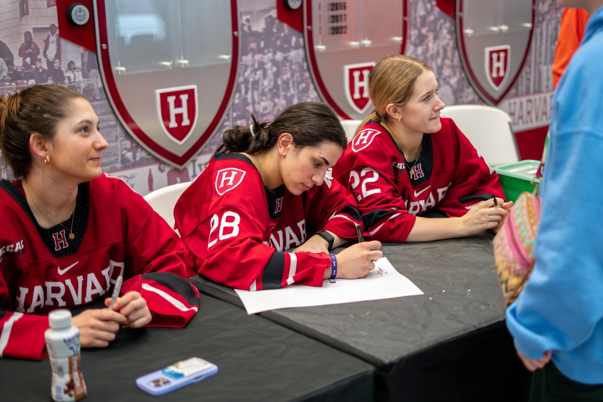 Ella Lucia signing autographs.