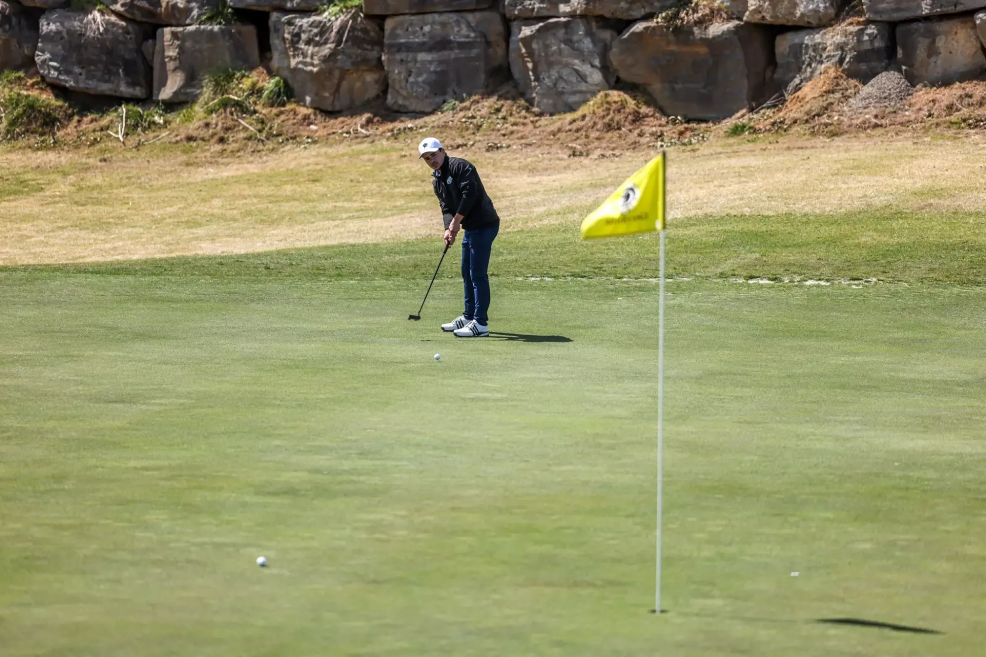 Men's Golf Student Athlete Kaleb Lambert hitting a golf ball  