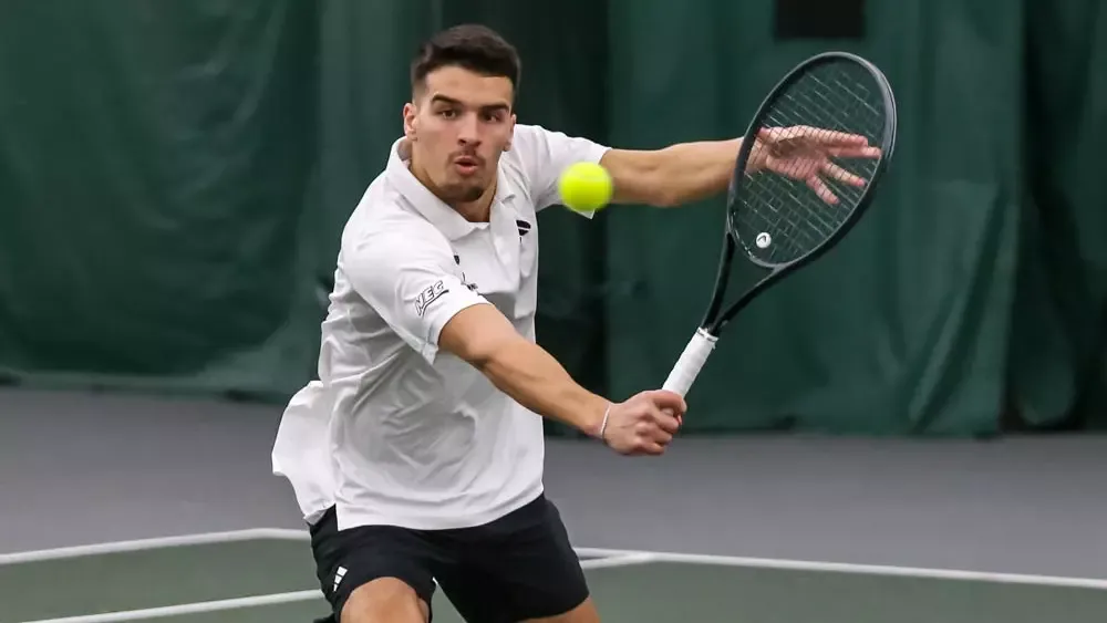 Tennis Student Athlete Joao Teixeria hitting a tennis ball 